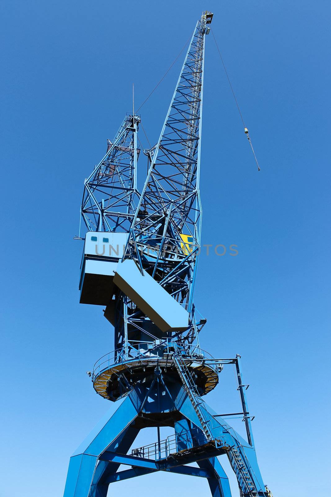 Shipyard crane against the blue sky by NickNick