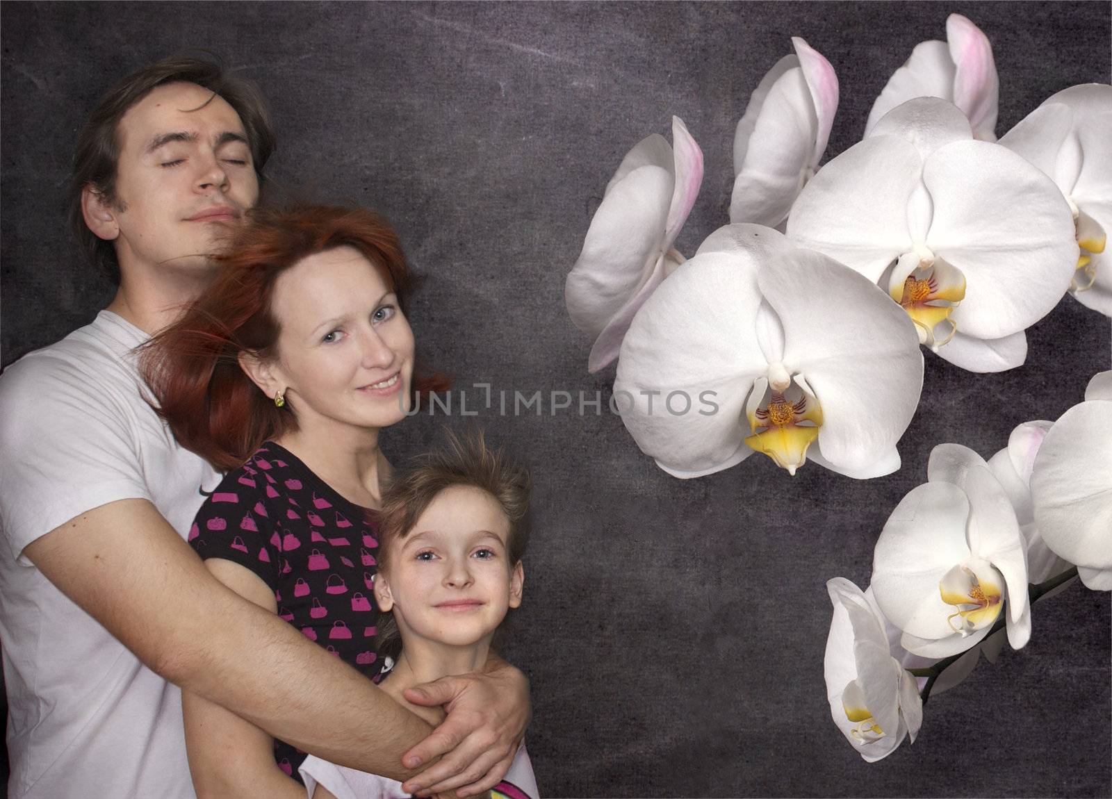 Happy parents with daughter and white orchid