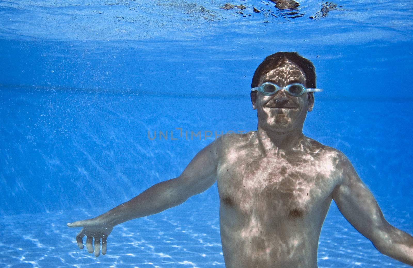 Crazy man under water in the pool