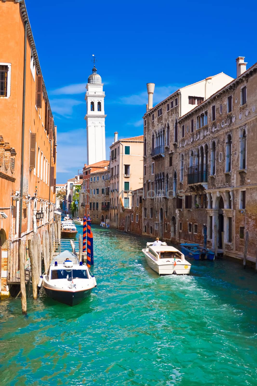 white boats in a canal in Venice, Italy