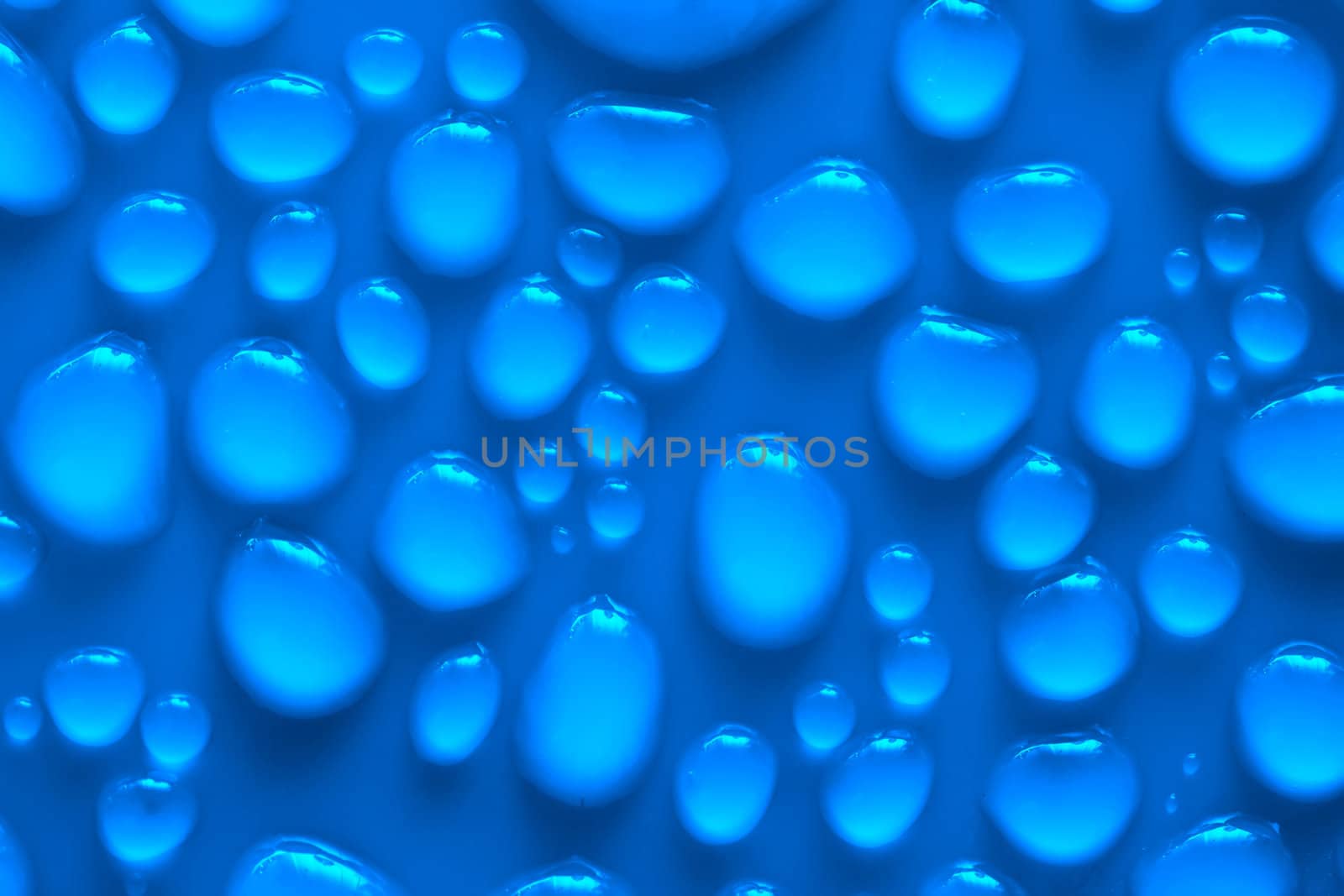 Water drops on a blue surface