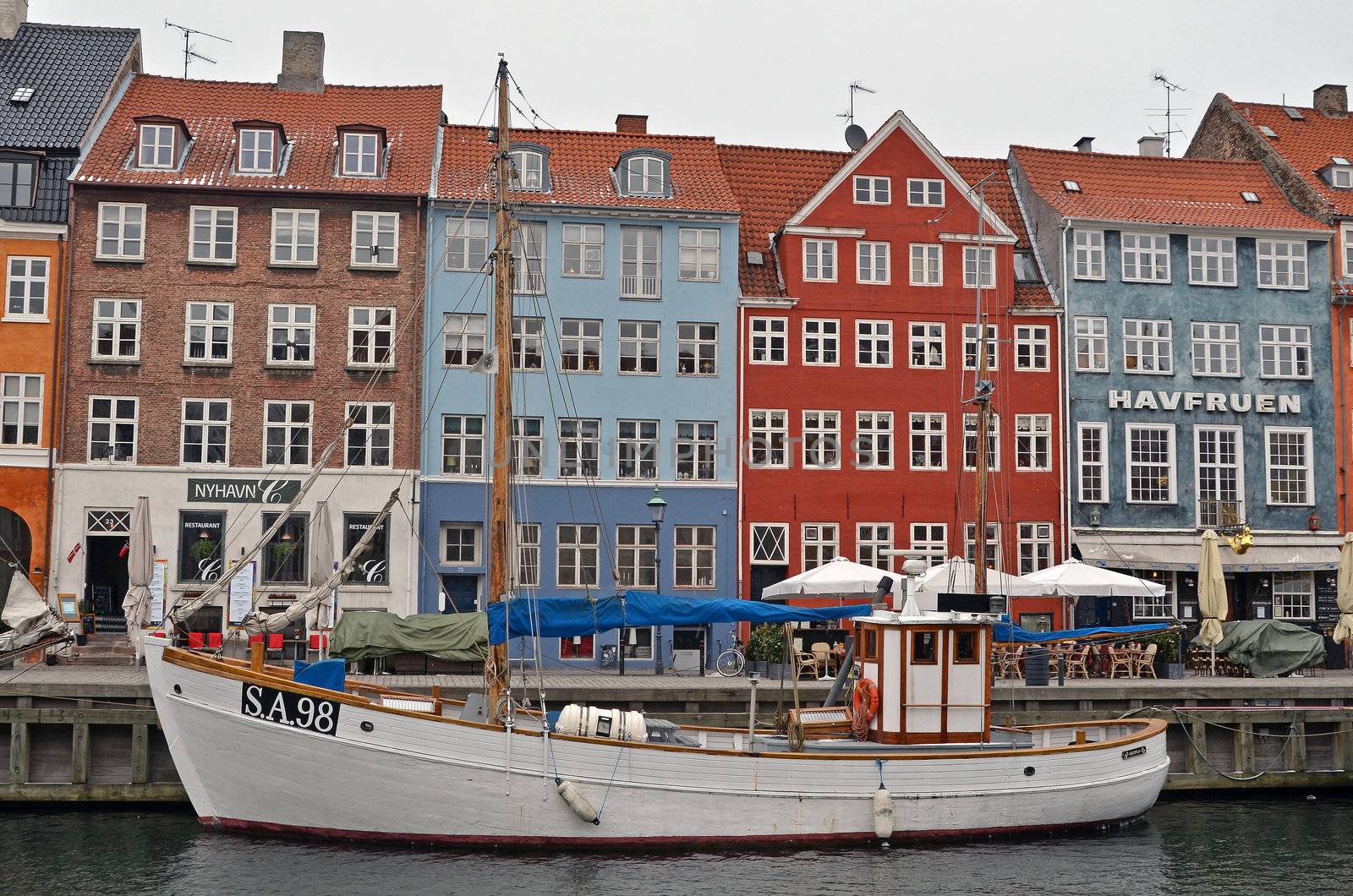View from Nyhavn in Copenhagen, Denmark with a fishing boat moored.