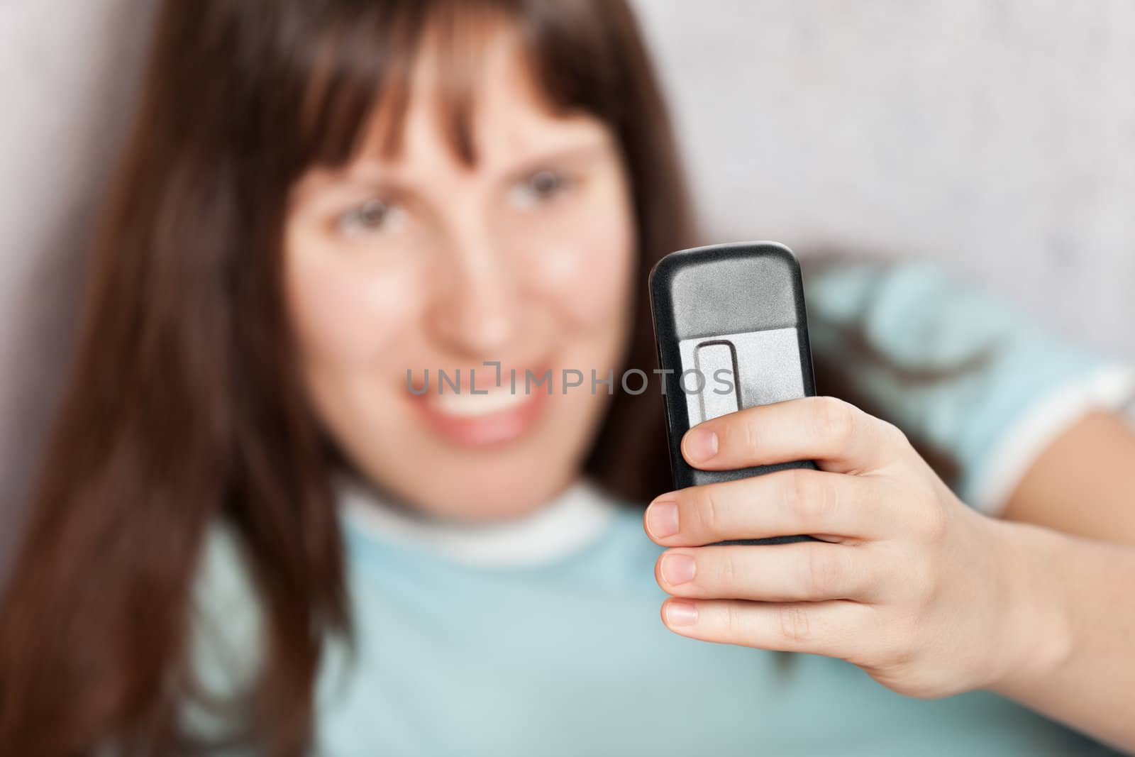 Smiling woman hand holding mobile communication phone