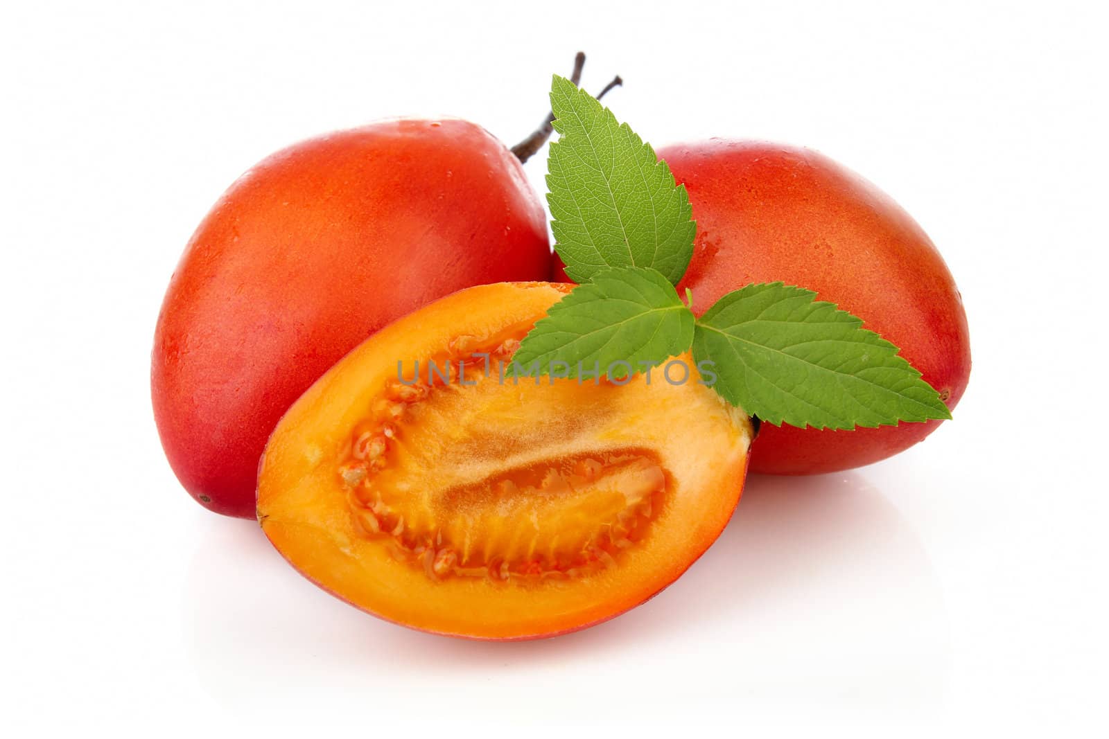 Sliced ripe Tamarillo fruits isolated on white background