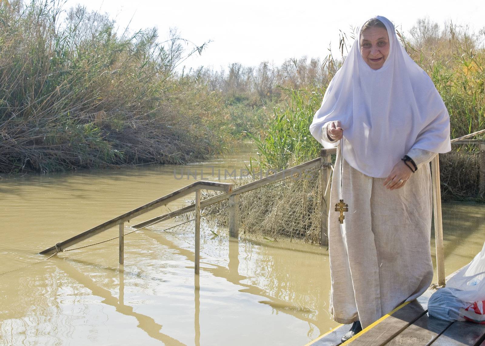 QASER EL YAHUD , ISRAEL - JAN 18 : Unidentified pilgrim woman participates in the baptising ritual during the epiphany at Qaser el yahud , Israel in January 18 2012