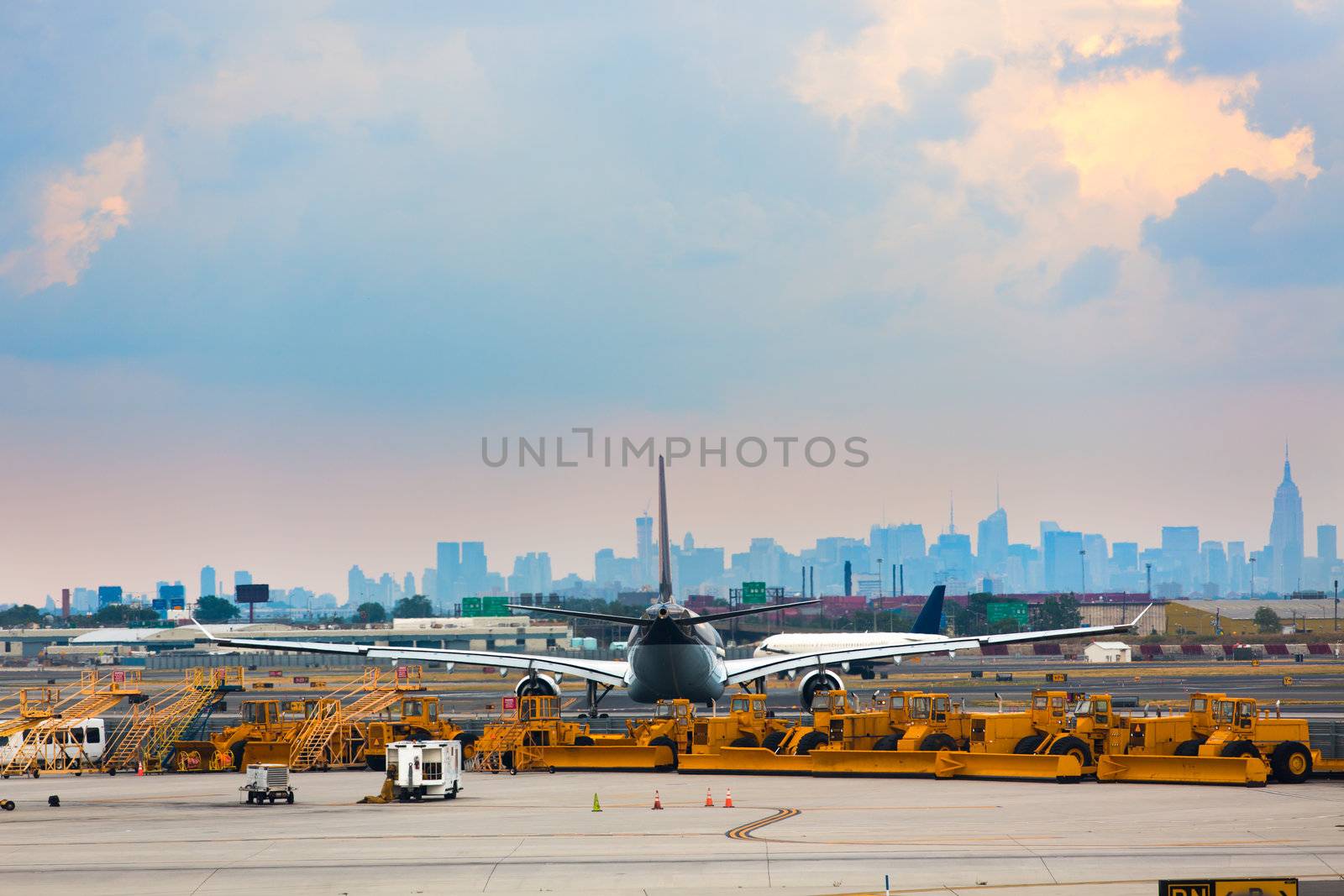 Airports runway and ground services waiting to service. With an airplane in-front of city.