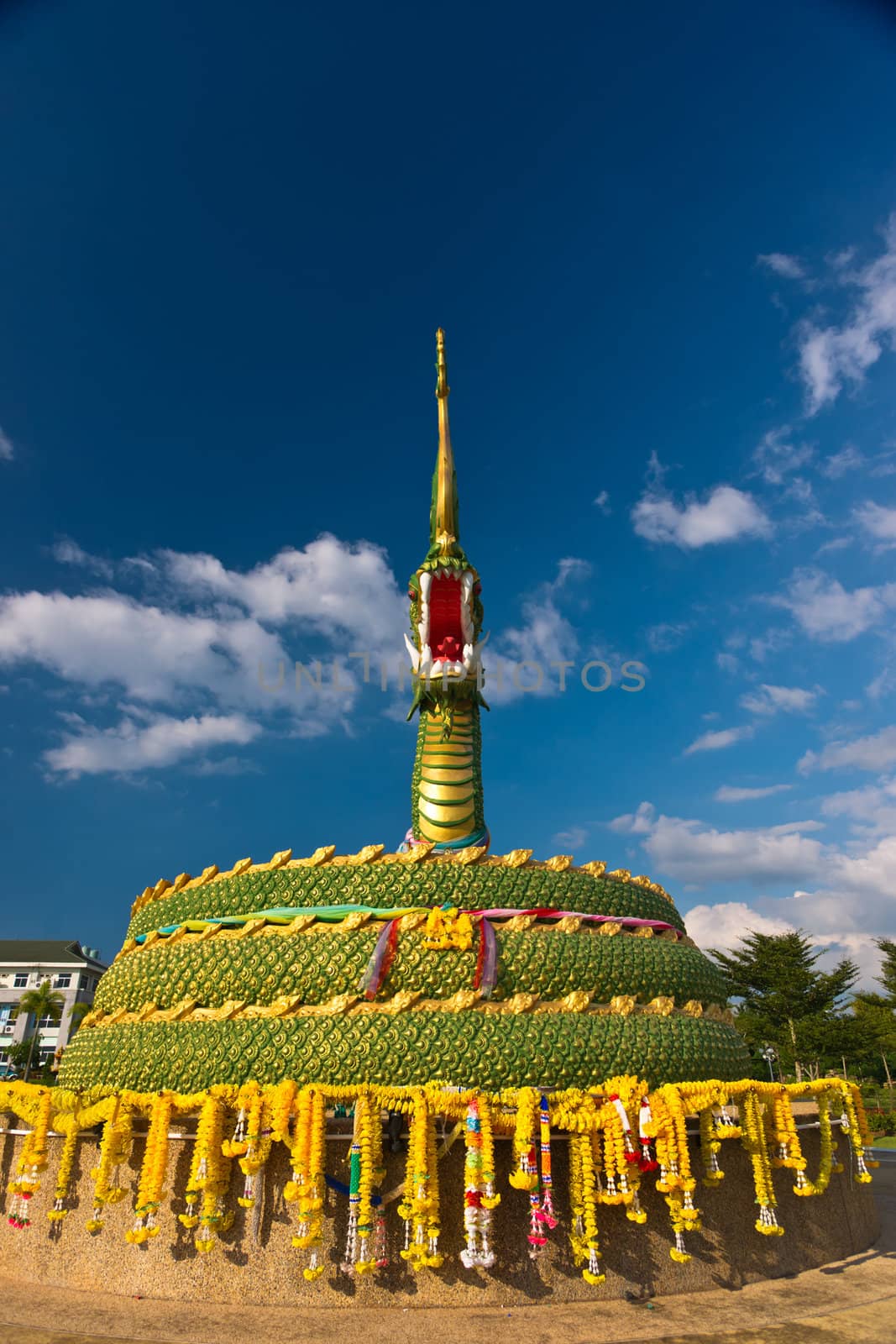 The statue of asian dragon on the cloudy sky background