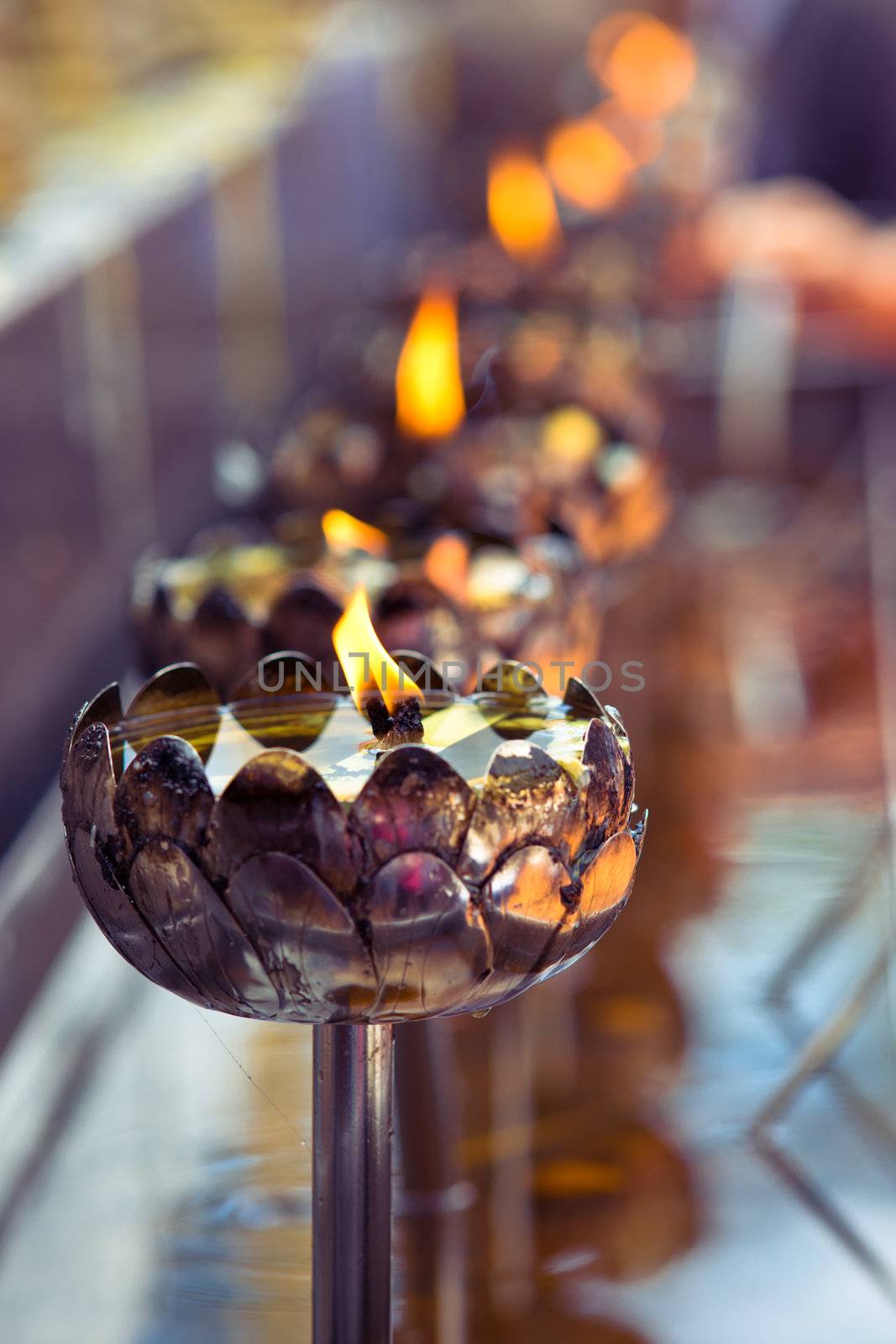 Sacramental light of candles in buddhist temple Wat Doi Suthep, Chiang Mai, Thailand