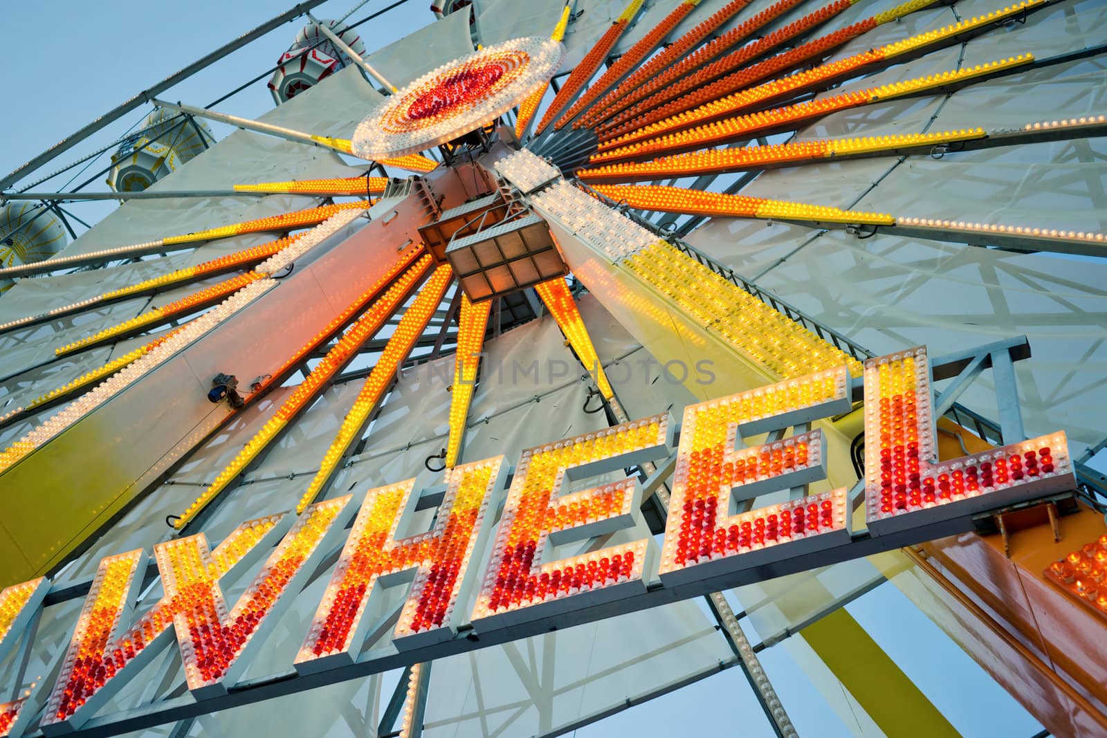 Ferris wheel with glowing letters "WHEEL" on it