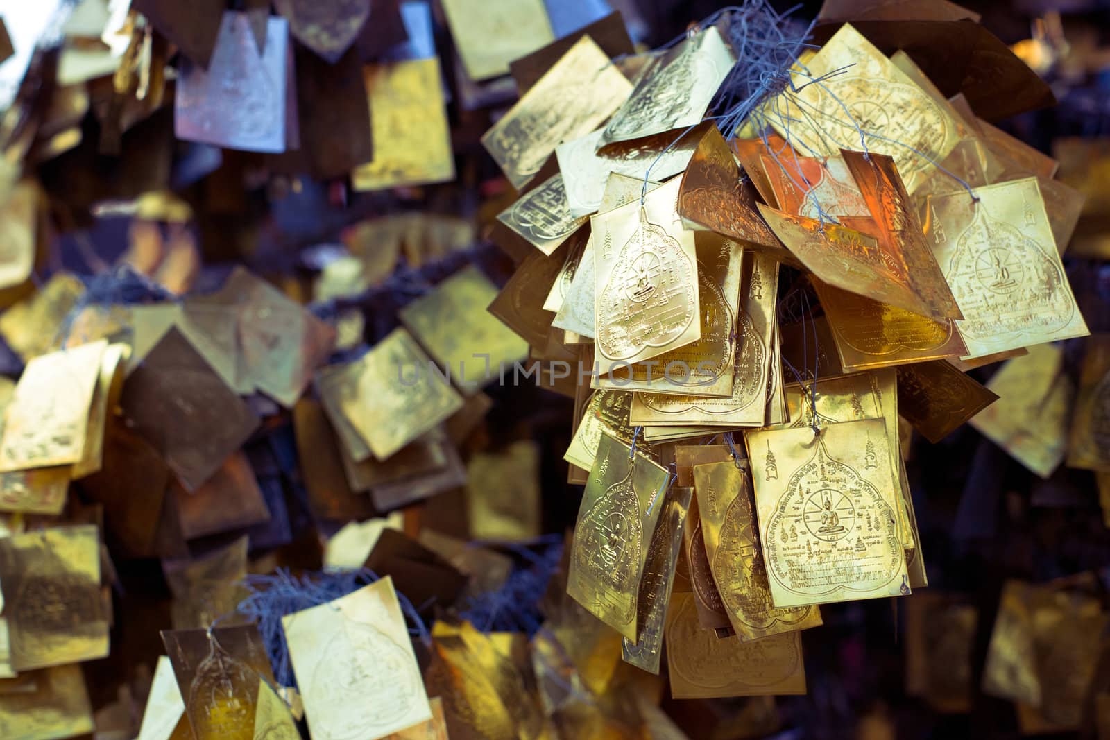 Religious golden cards hanging in the asian temple
