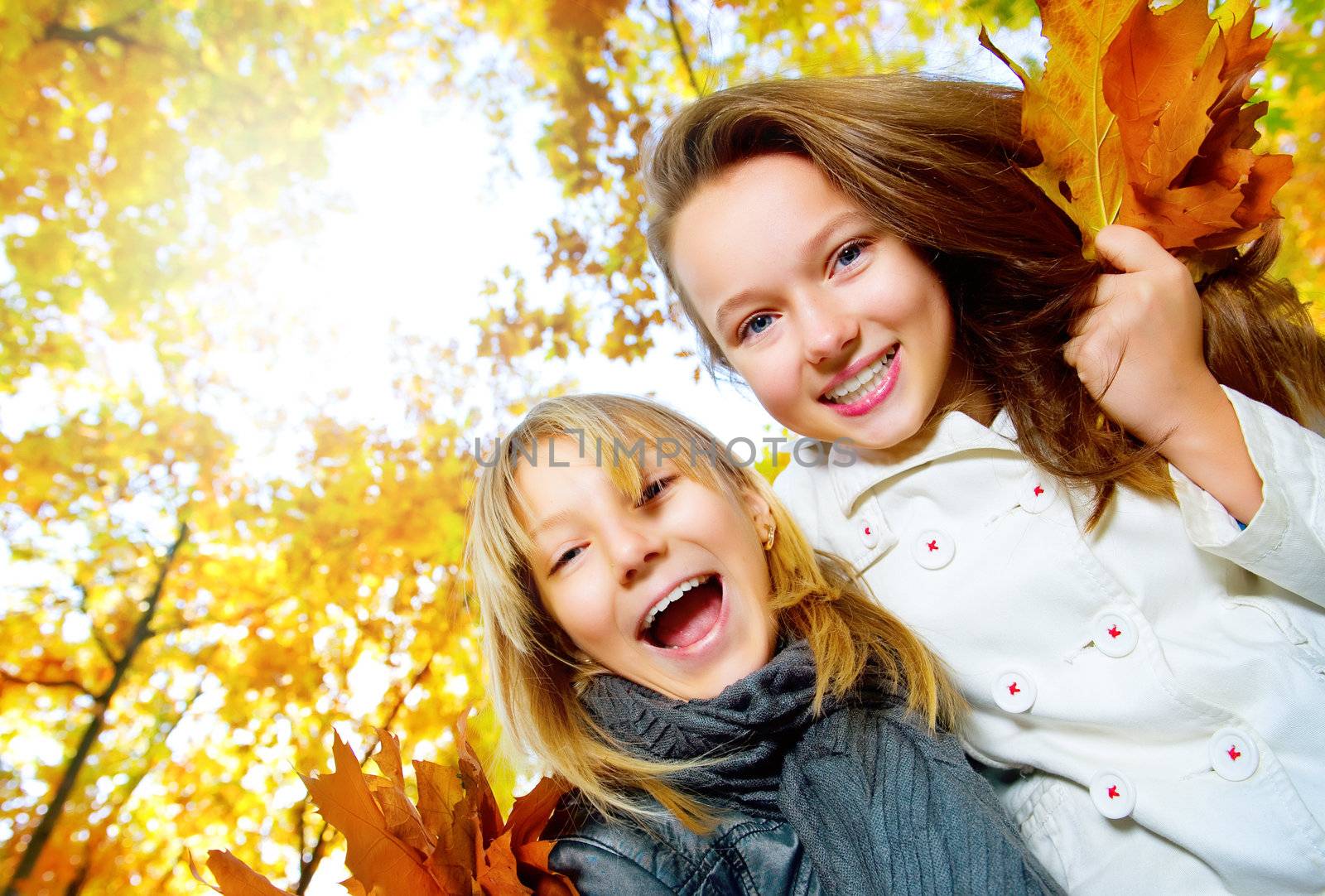 Beautiful Teenage Girls Having Fun in Autumn Park .Outdoor by SubbotinaA