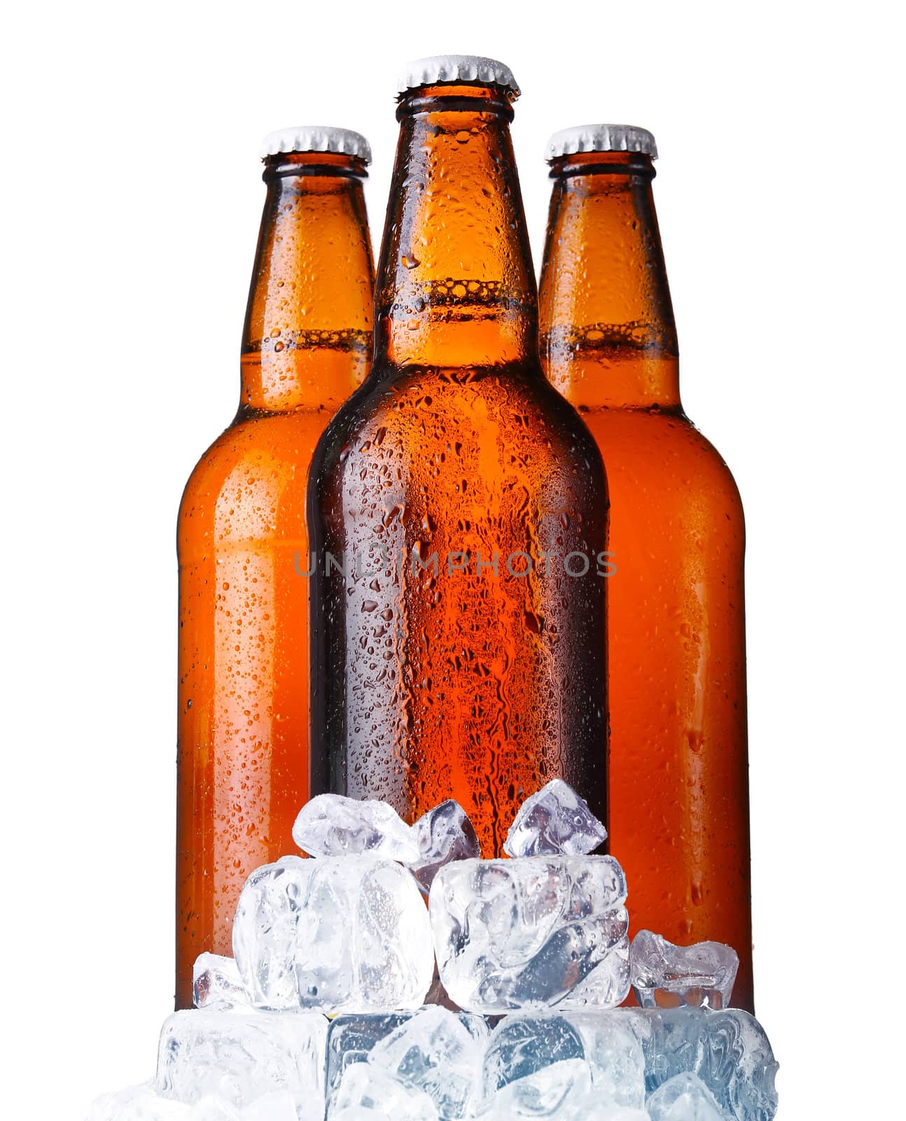 Three brown bottles of beer with ice isolated on white background