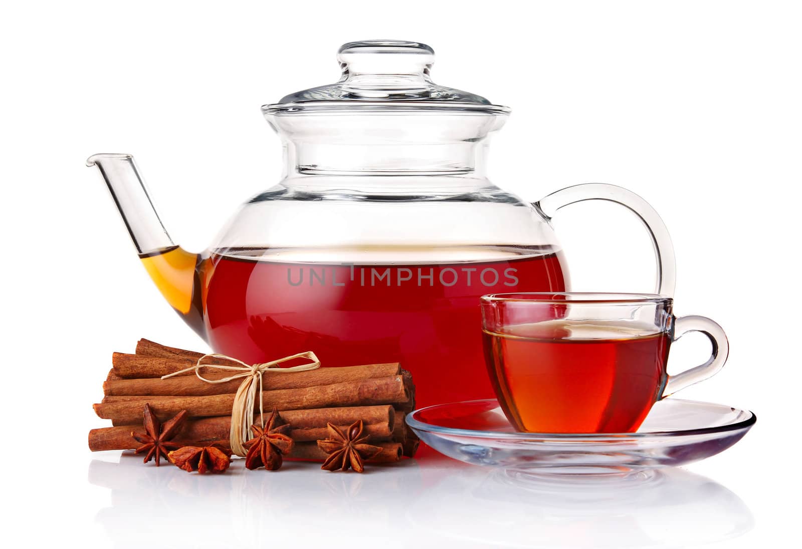 Glass teapot and cup of tea with spices isolated on white background