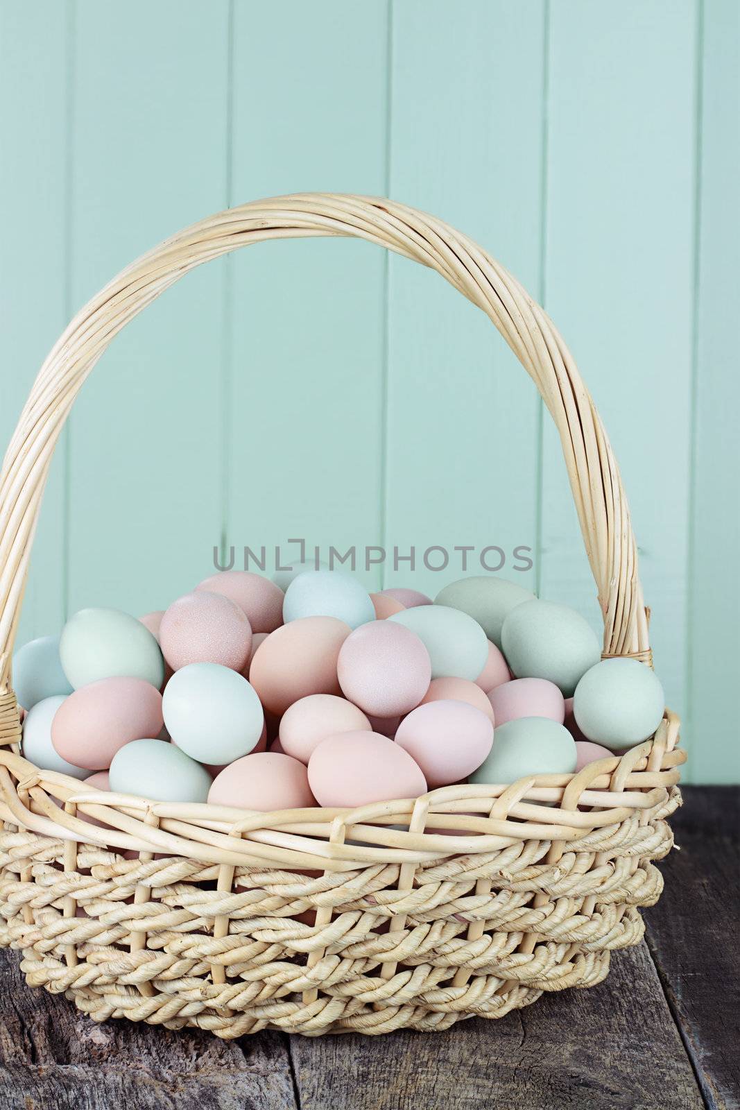 Large basket filled with fresh free range eggs. 
