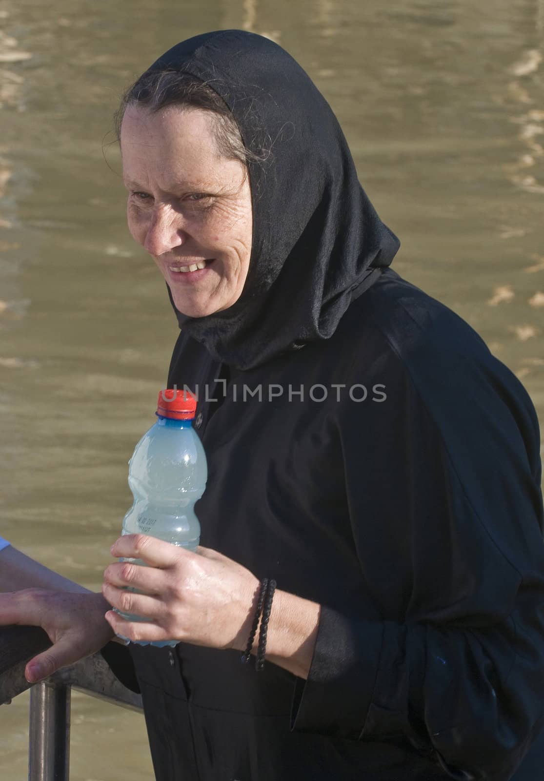 QASER EL YAHUD , ISRAEL - JAN 18 : Unidentified nun participates in the baptising ritual during the epiphany at Qaser el yahud , Israel in January 18 2012