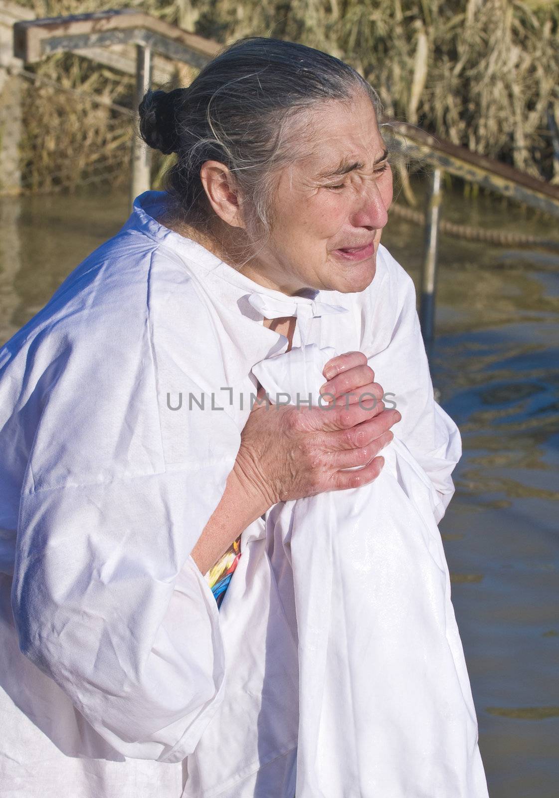 QASER EL YAHUD , ISRAEL - JAN 18 : Unidentified pilgrim woman participates in the baptising ritual during the epiphany at Qaser el yahud , Israel in January 18 2012