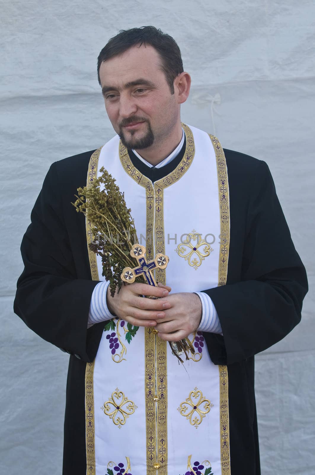 QASER EL YAHUD , ISRAEL - JAN 18 : Greek orthodox priest participates in the baptising ritual during the epiphany at Qaser el yahud , Israel in January 18 2012