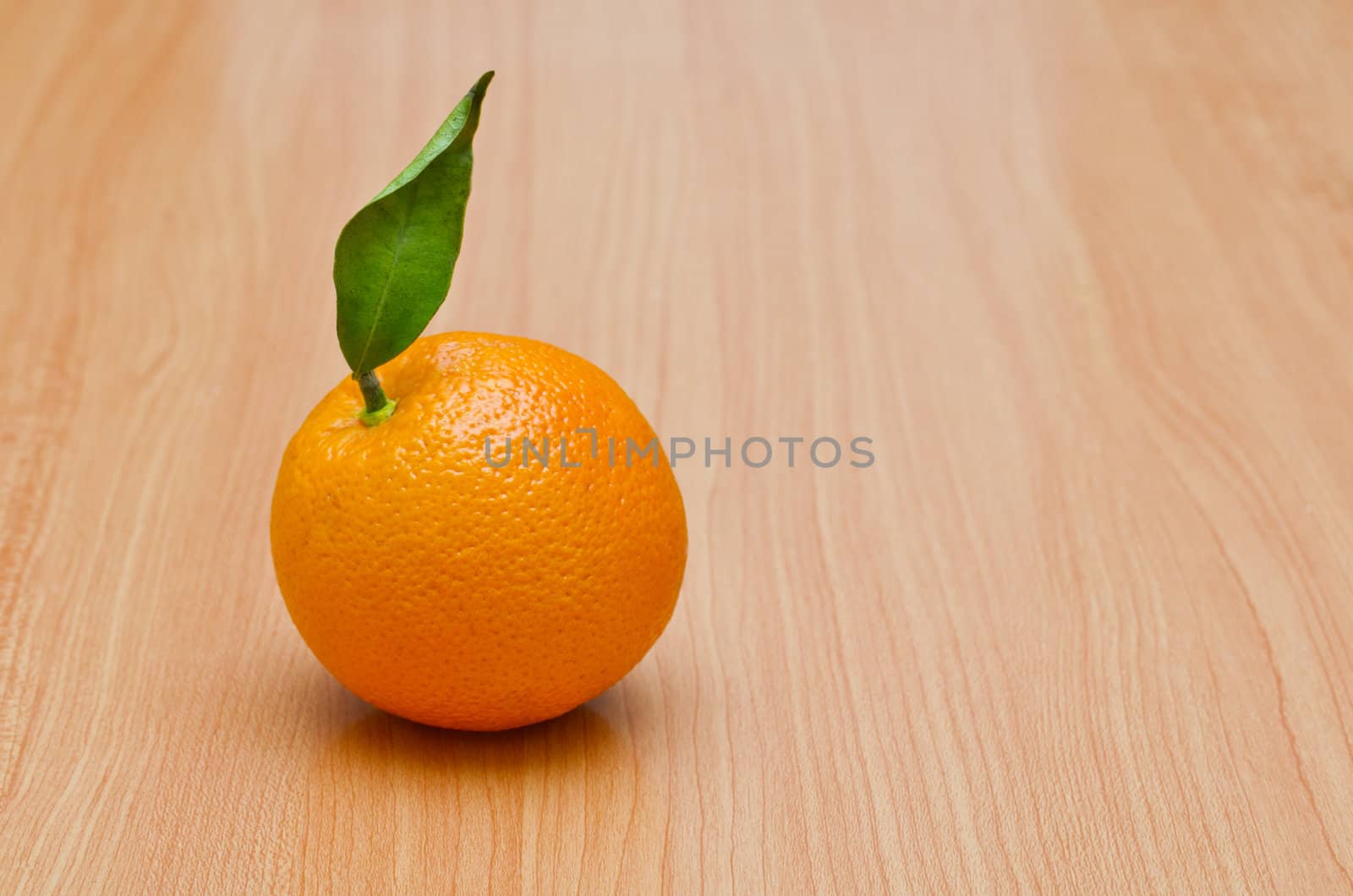 Natural looking orange on the wooden table, Horizontal shot