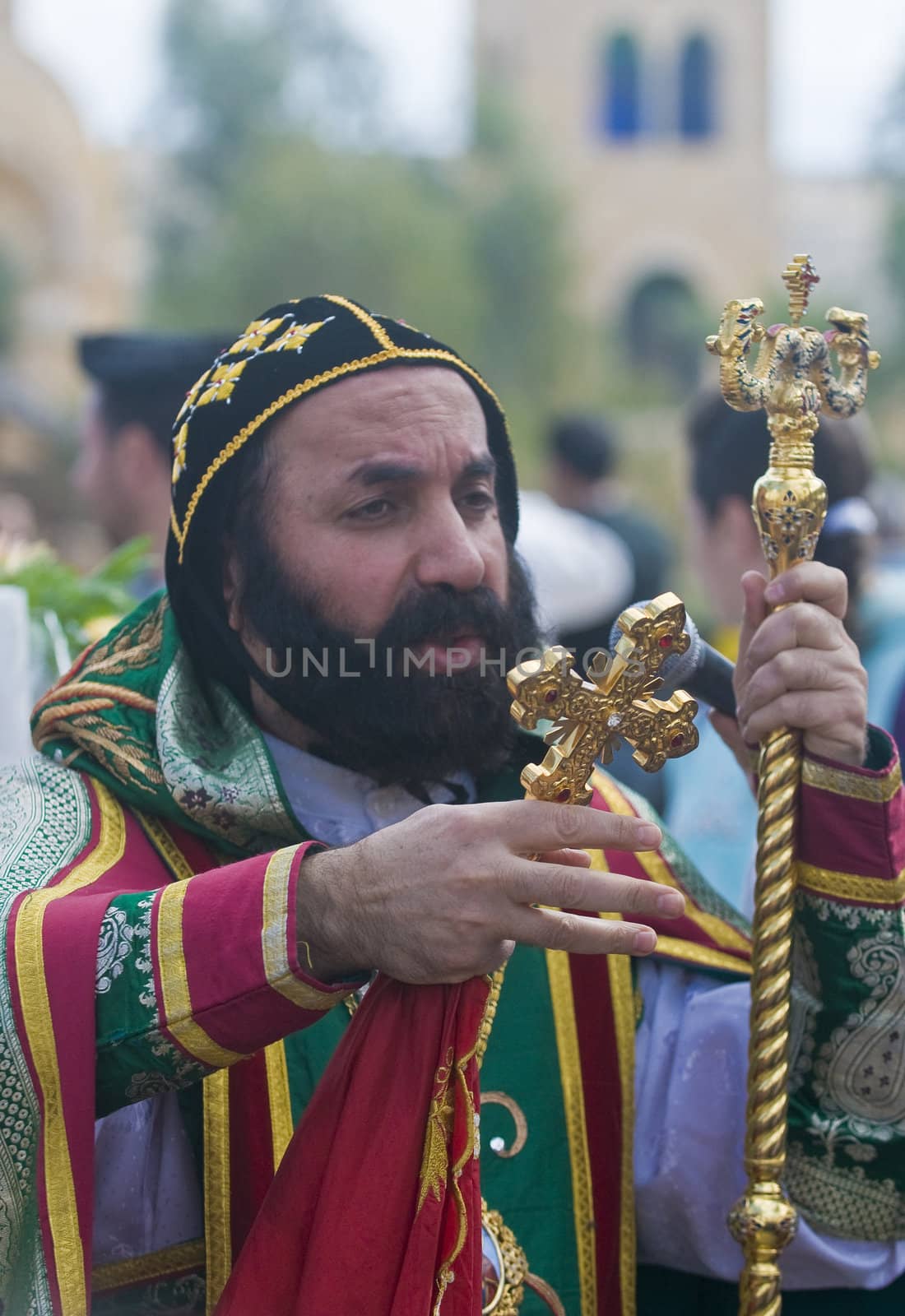 QASER EL YAHUD , ISRAEL - JAN 19 : Syrian Orthodox priest participates in the annual baptising ceremony during the epiphany at Qaser el yahud , Israel in January 19 2012