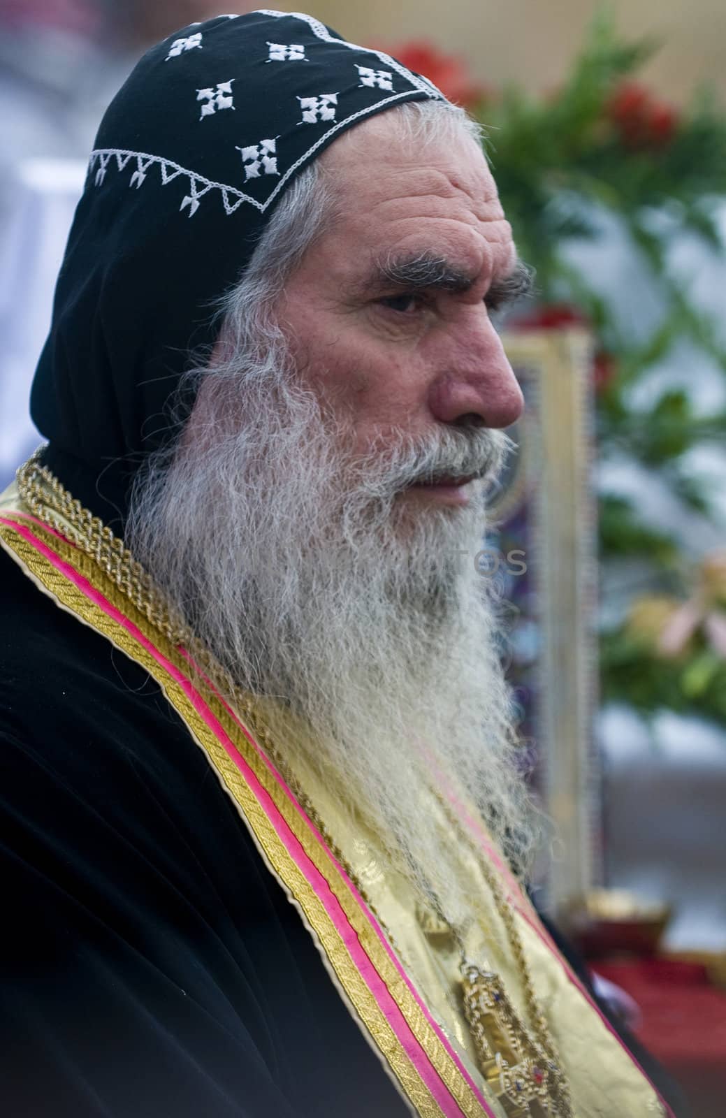 QASER EL YAHUD , ISRAEL - JAN 19 : Syrian Orthodox priest participates in the annual baptising ceremony during the epiphany at Qaser el yahud , Israel in January 19 2012
