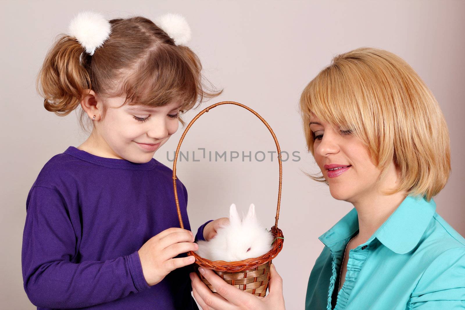 daughter and mother with dwarf white bunny pet 