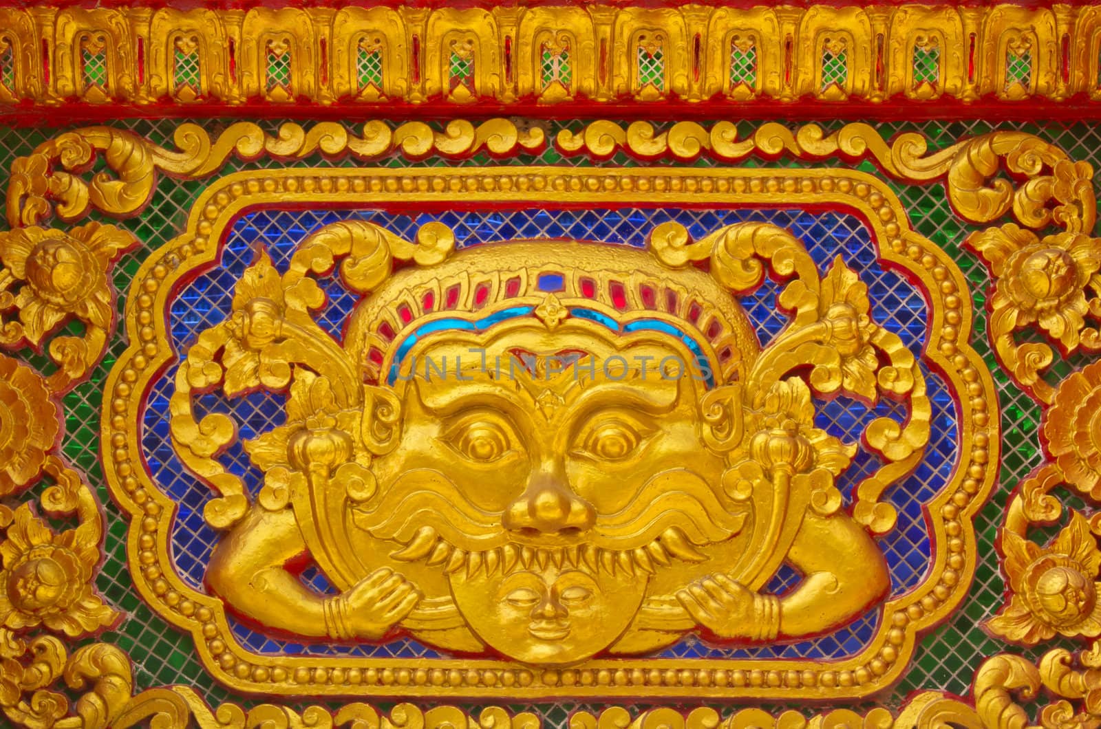 Gold stucco design of native thai style on the Wall