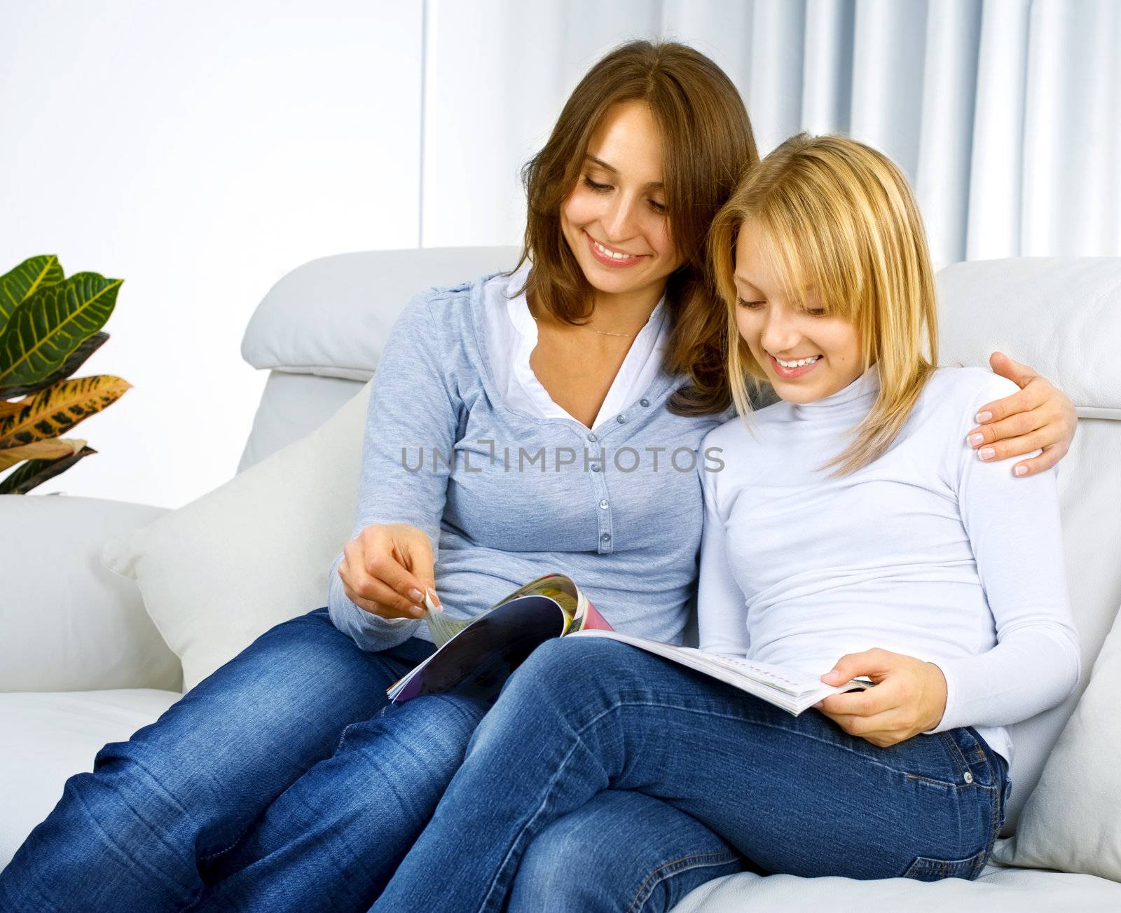 Mother with Teenage Daughter reading fashion Magazine by SubbotinaA