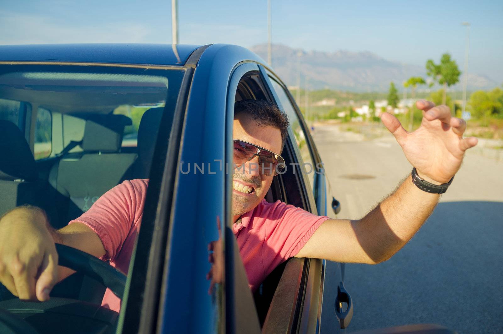 Driver hanging out of his car window gesticulating