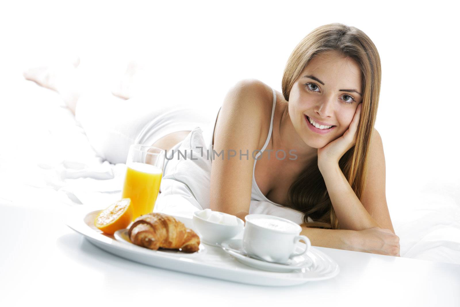 Young beautiful woman having breakfast in bed.