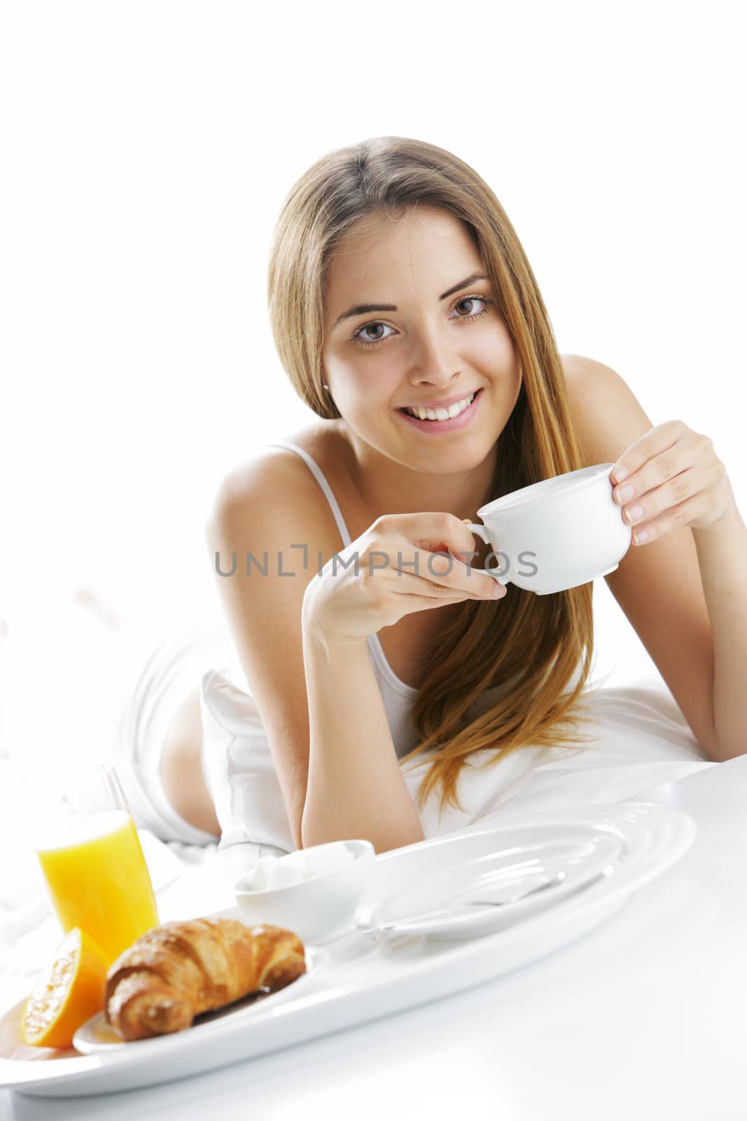 Young beautiful woman having breakfast in bed.