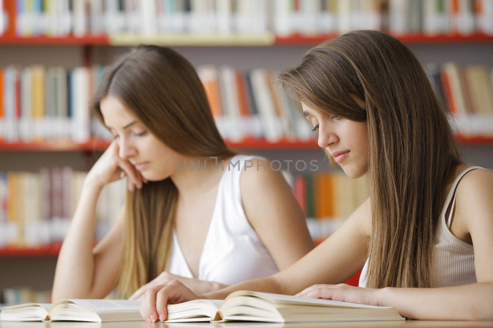 Candid capture of a pair of university students in the college library