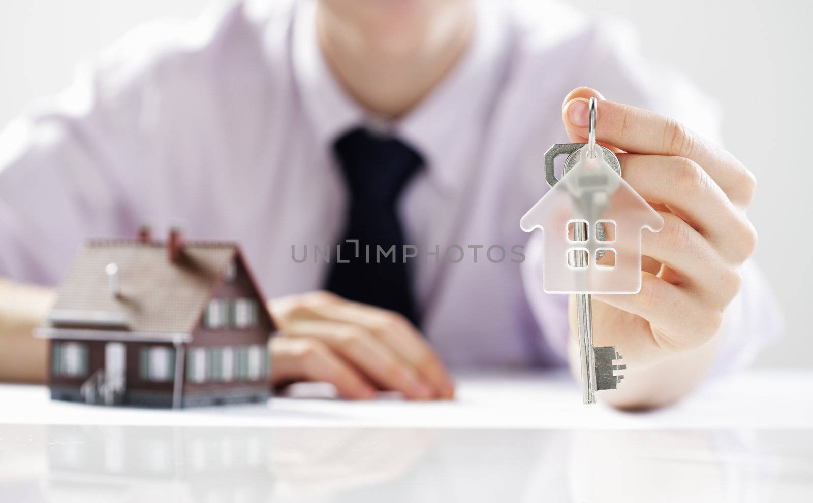 Young businessman giving house keys