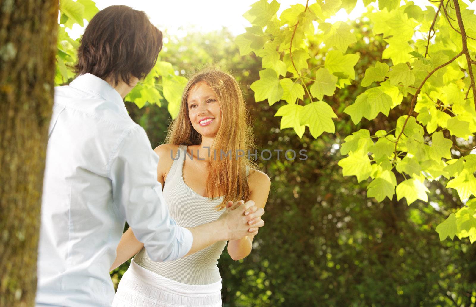 a young couple in love having fun in the park