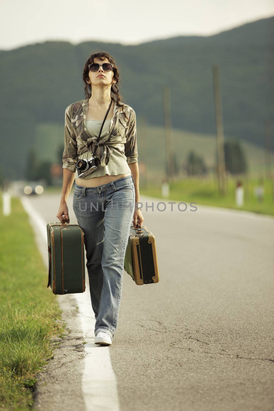 Young woman runaway walks away road