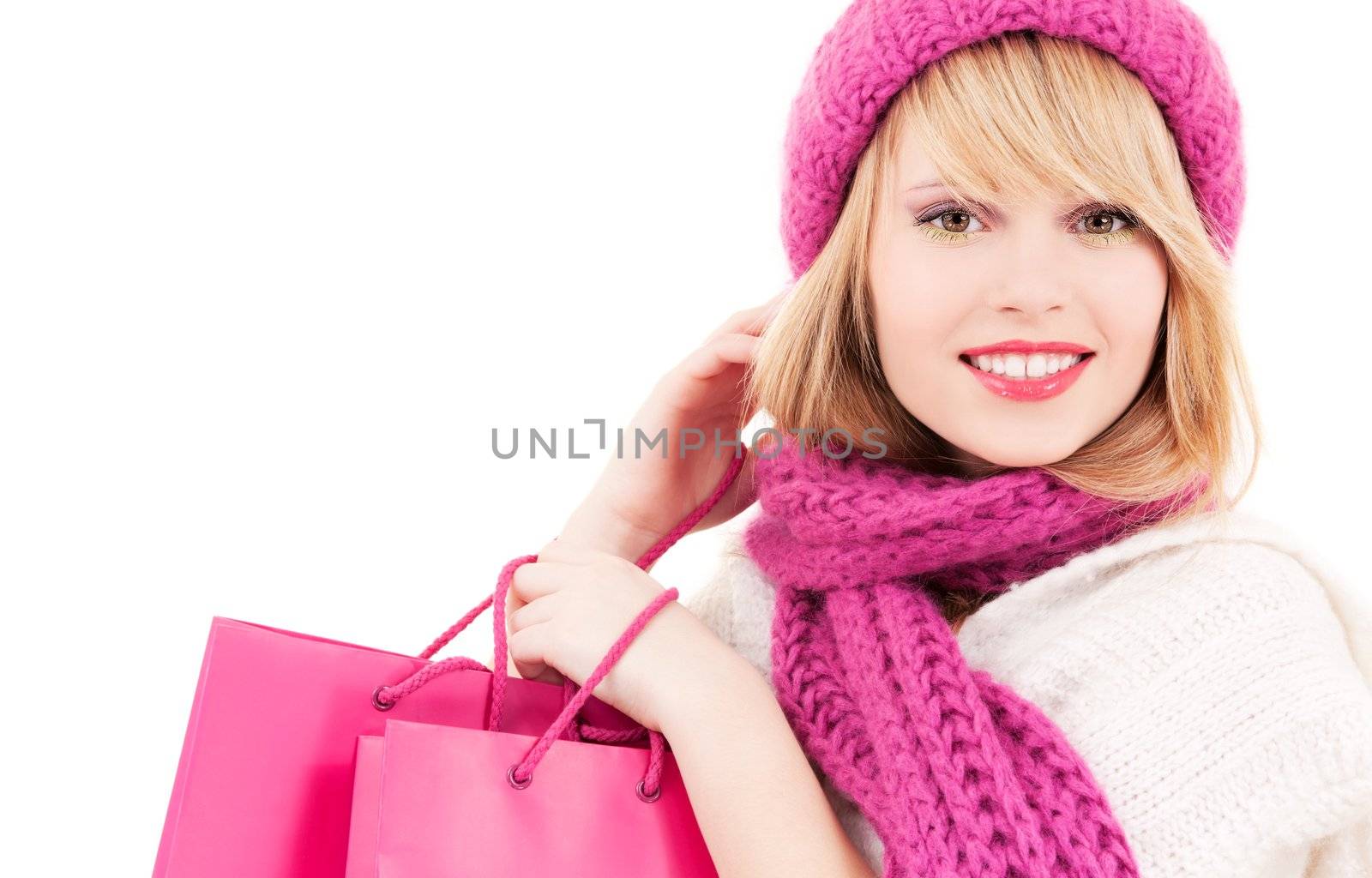 happy teenage girl in hat with pink shopping bags