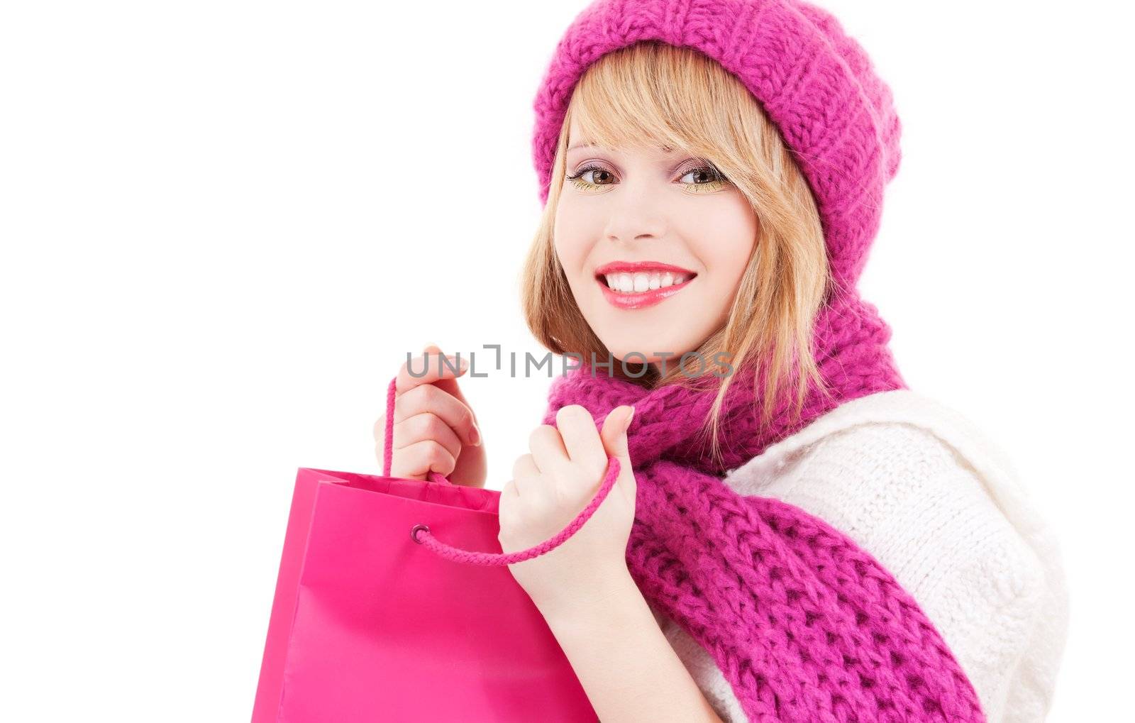 happy teenage girl in hat with pink shopping bags