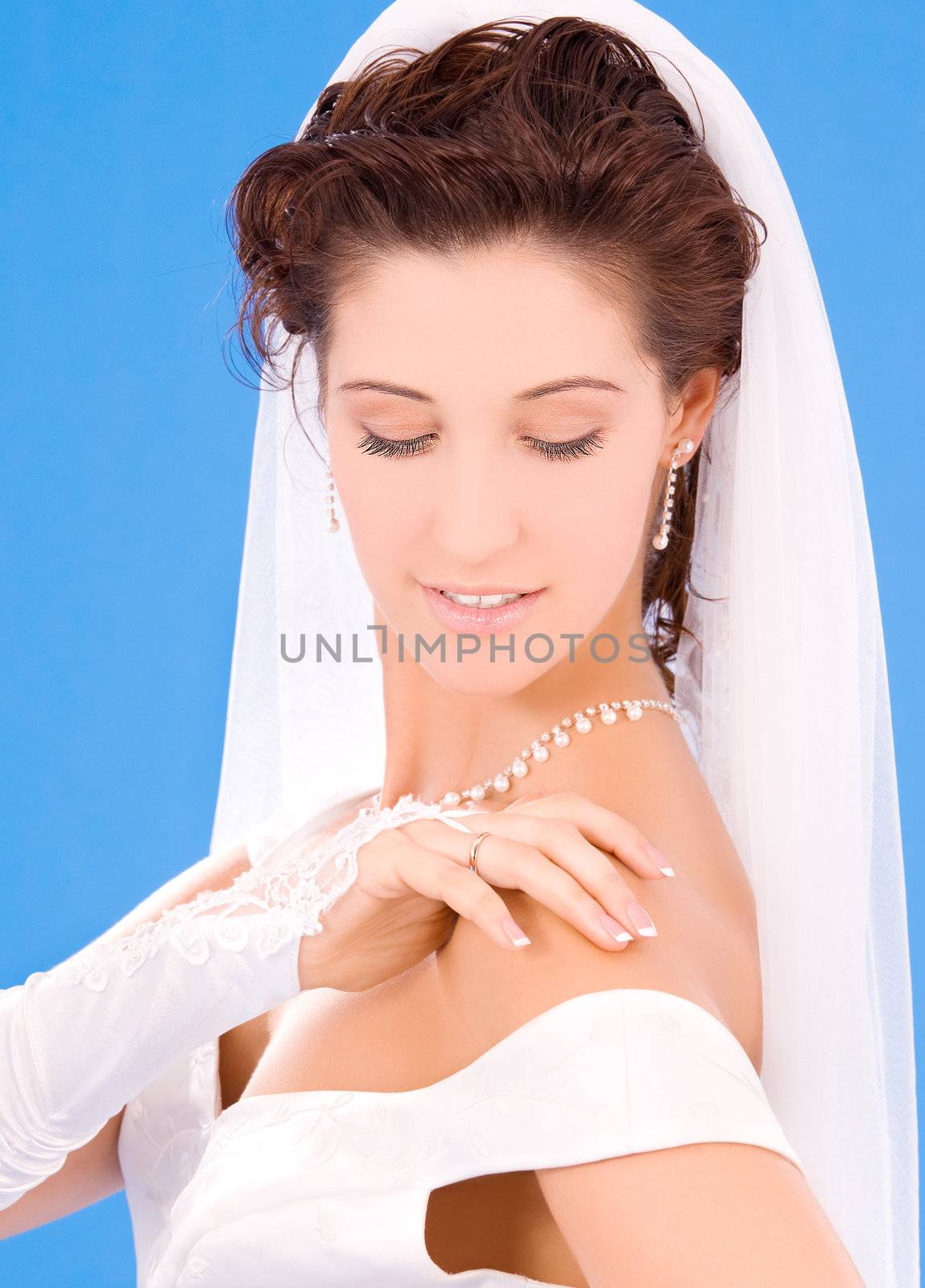 happy bride with her wedding ring over blue