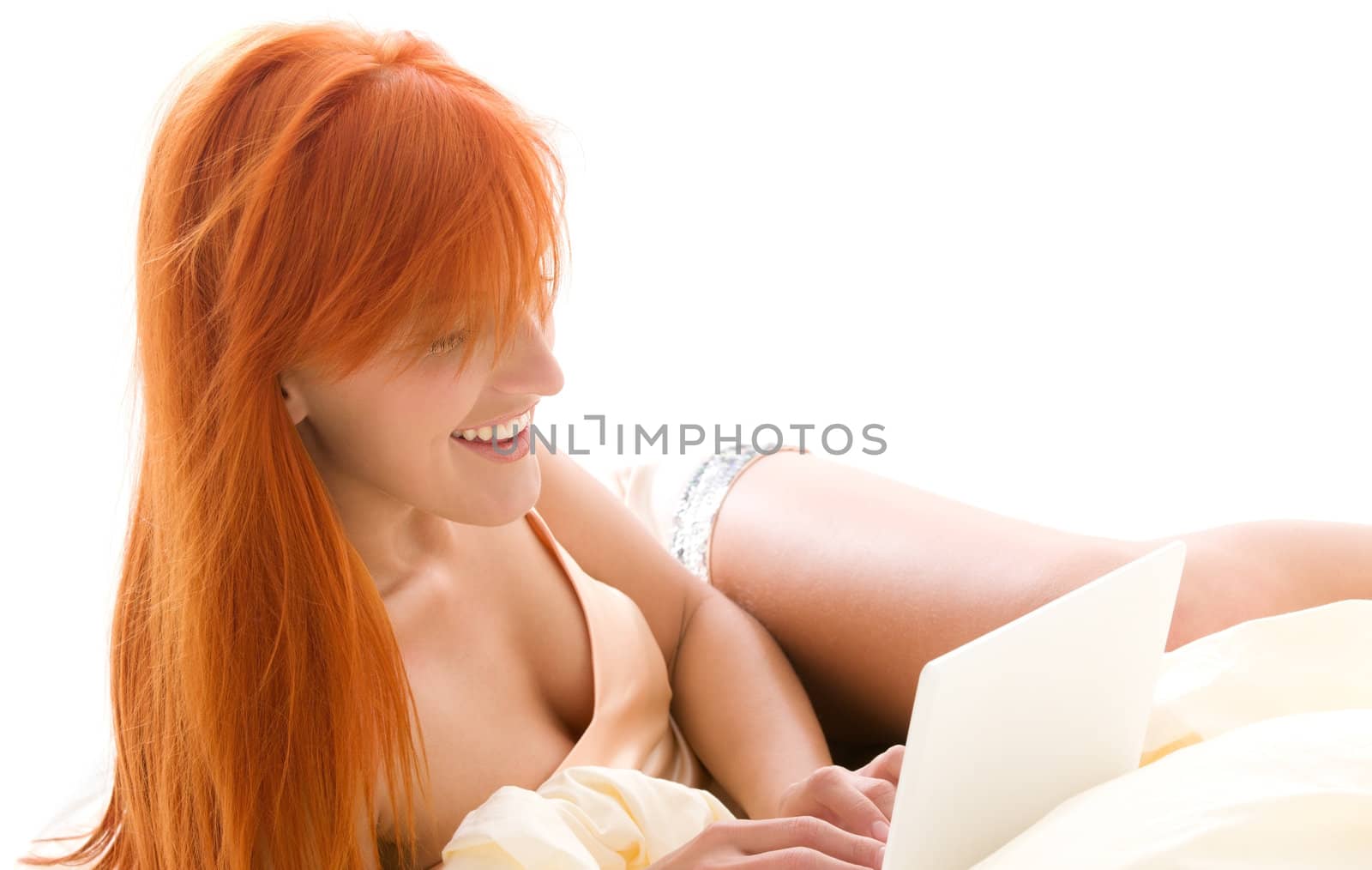 happy redhead woman with laptop computer by dolgachov