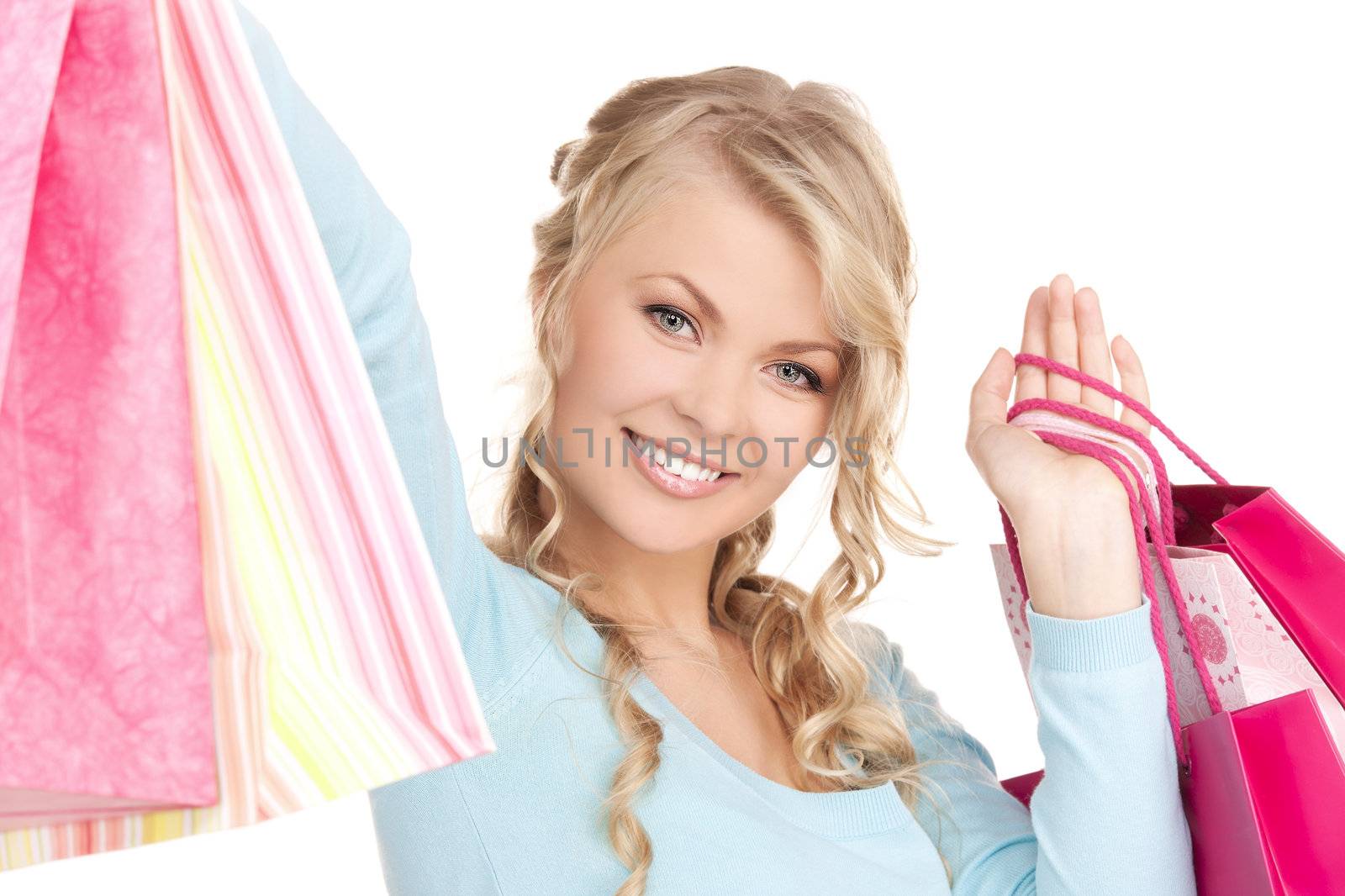 happy woman with shopping bags over white