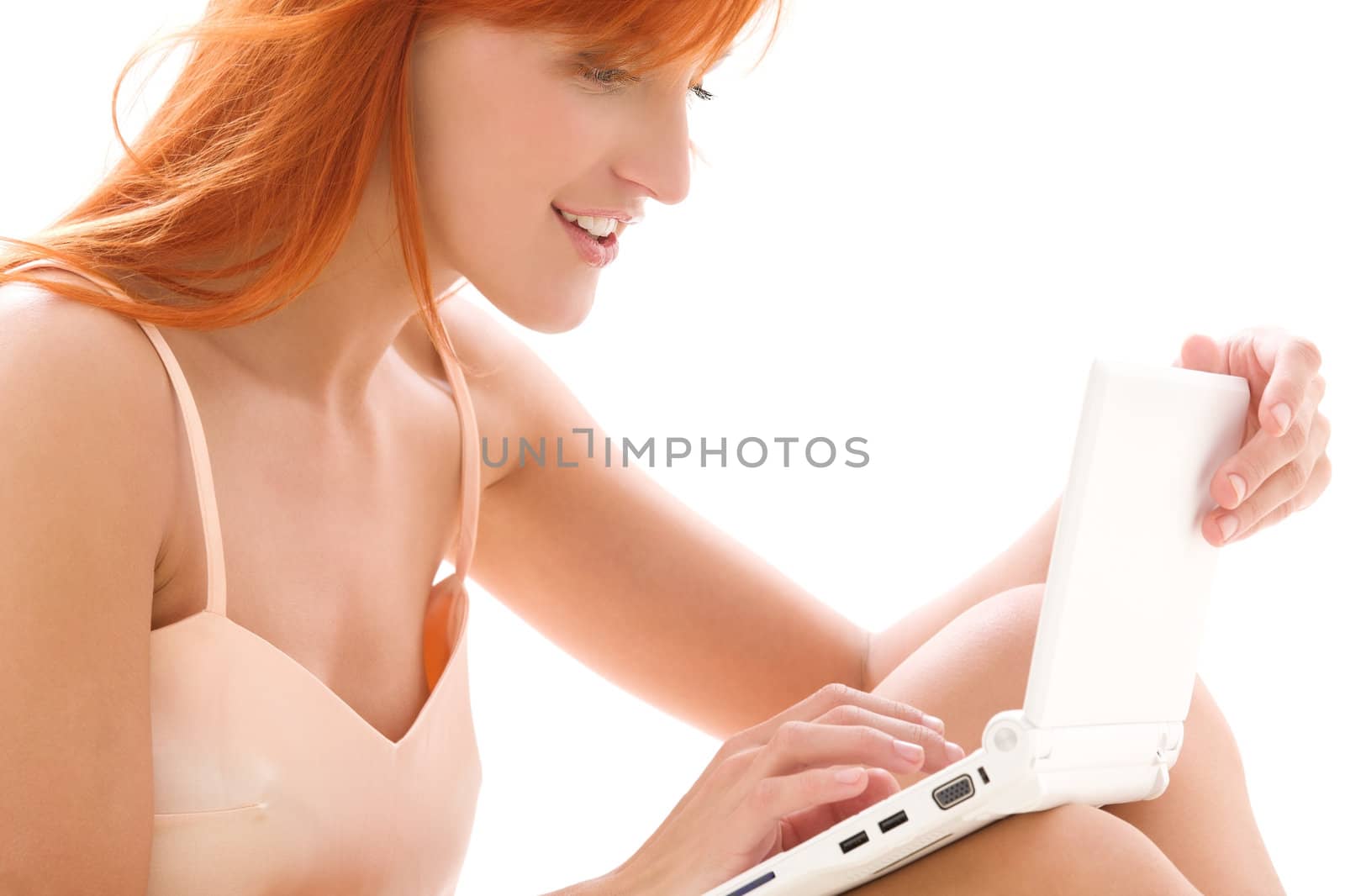 happy redhead woman with laptop computer by dolgachov