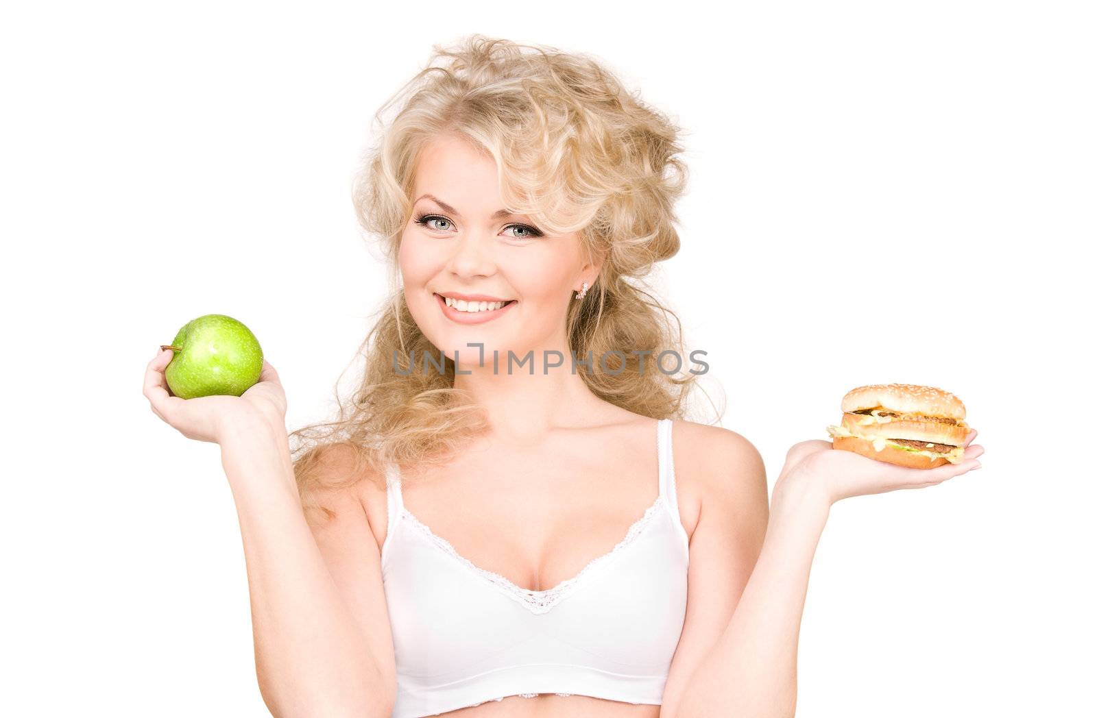 young beautiful woman choosing between burger and apple.