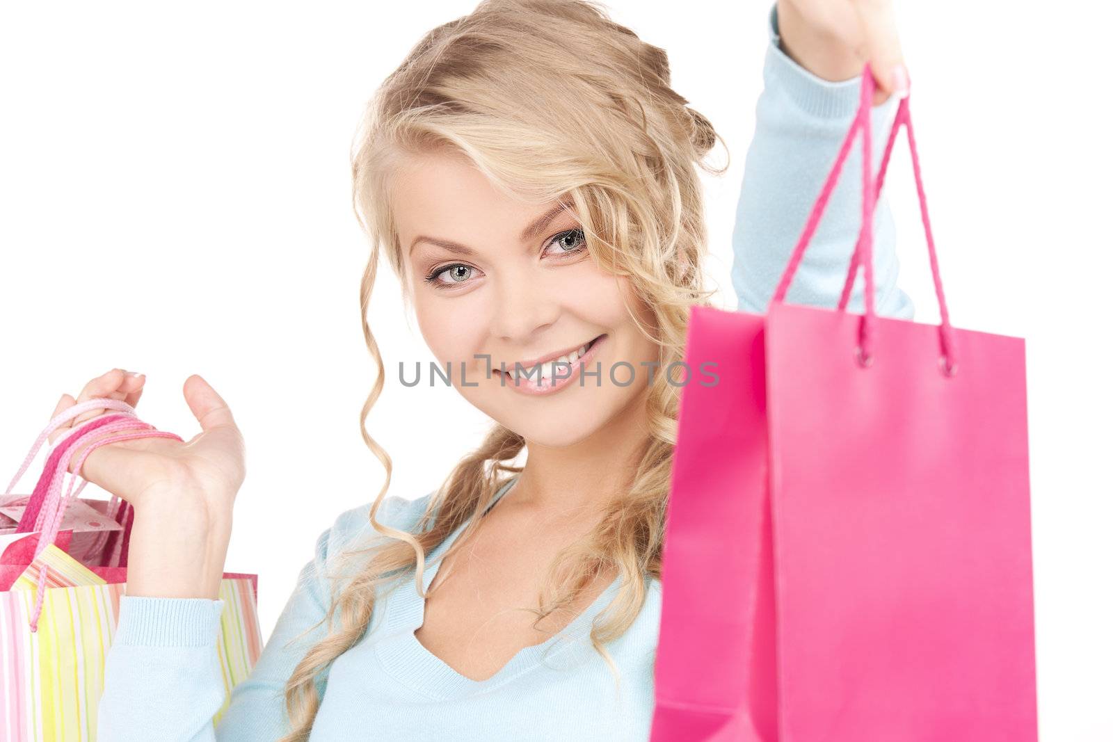 happy woman with shopping bags over white