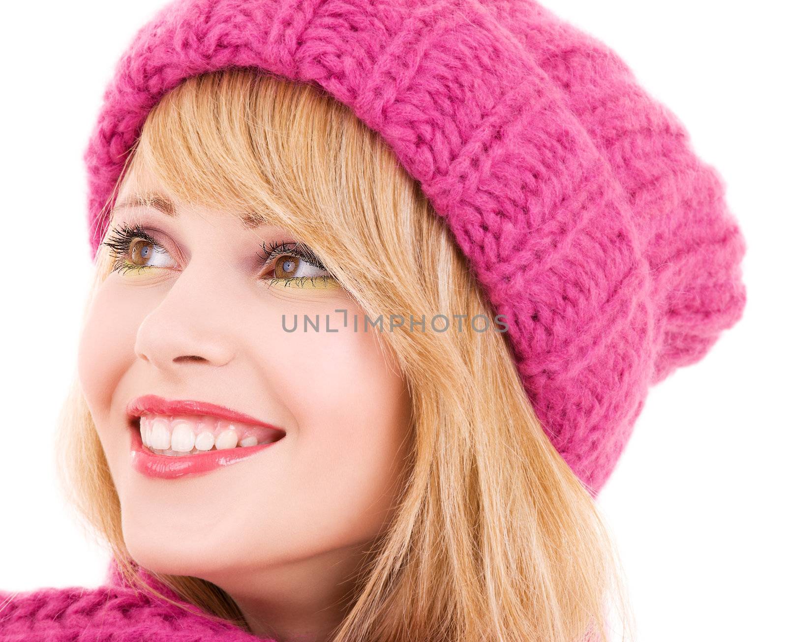 happy teenage girl in winter hat over white