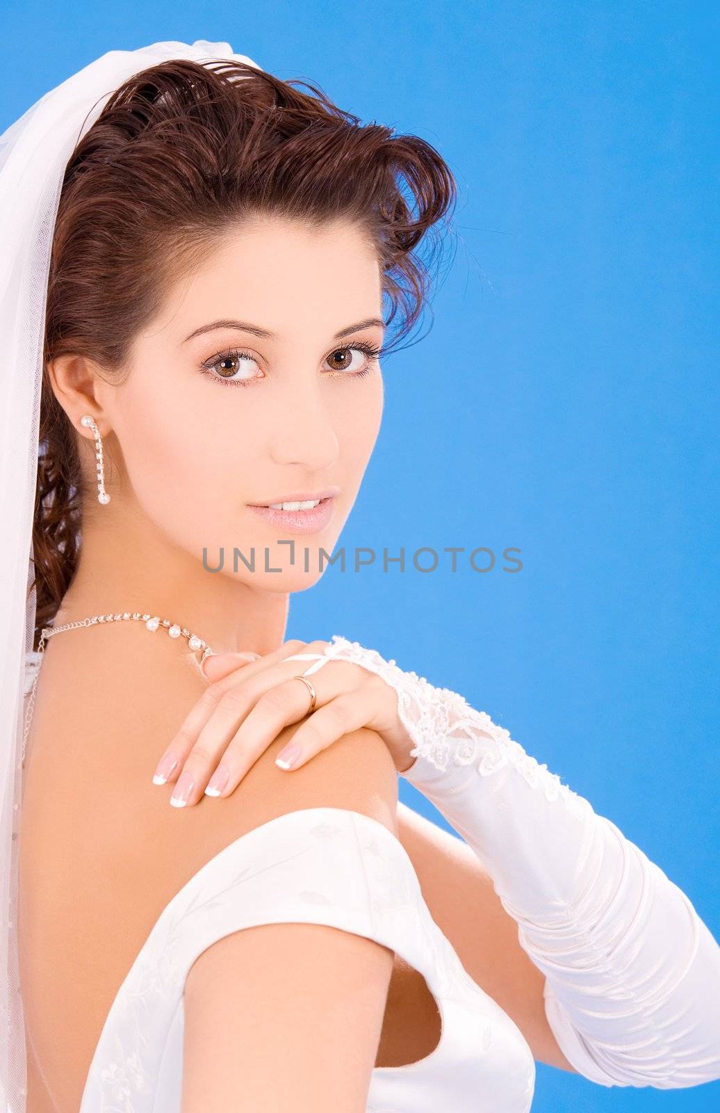 happy bride with her wedding ring over blue