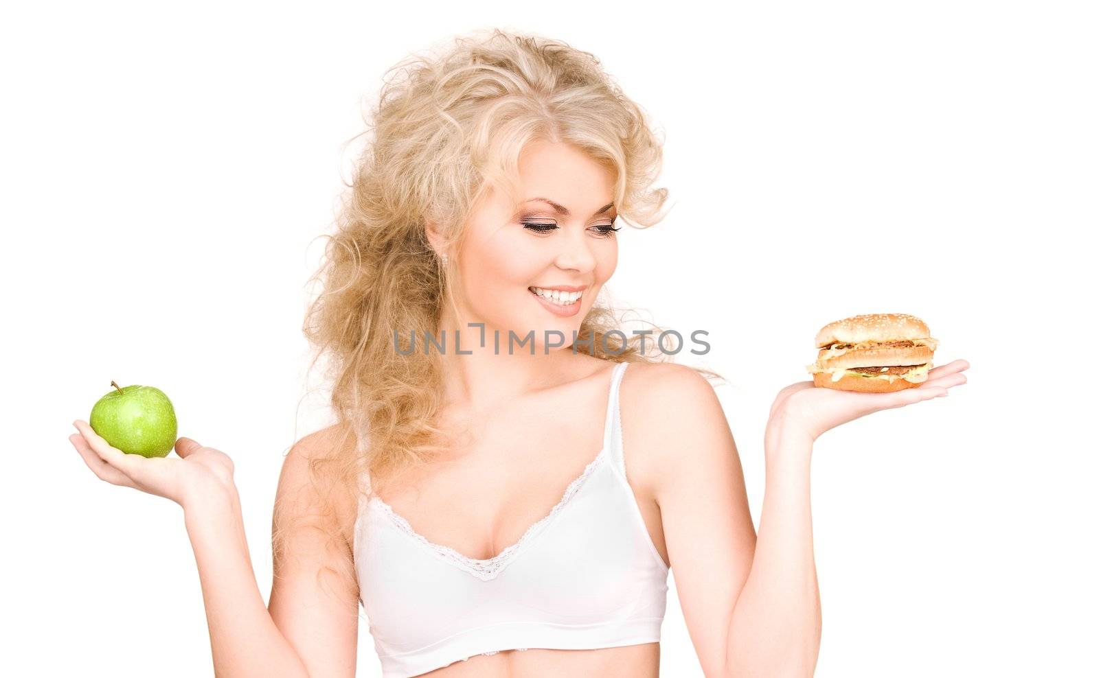 young beautiful woman choosing between burger and apple