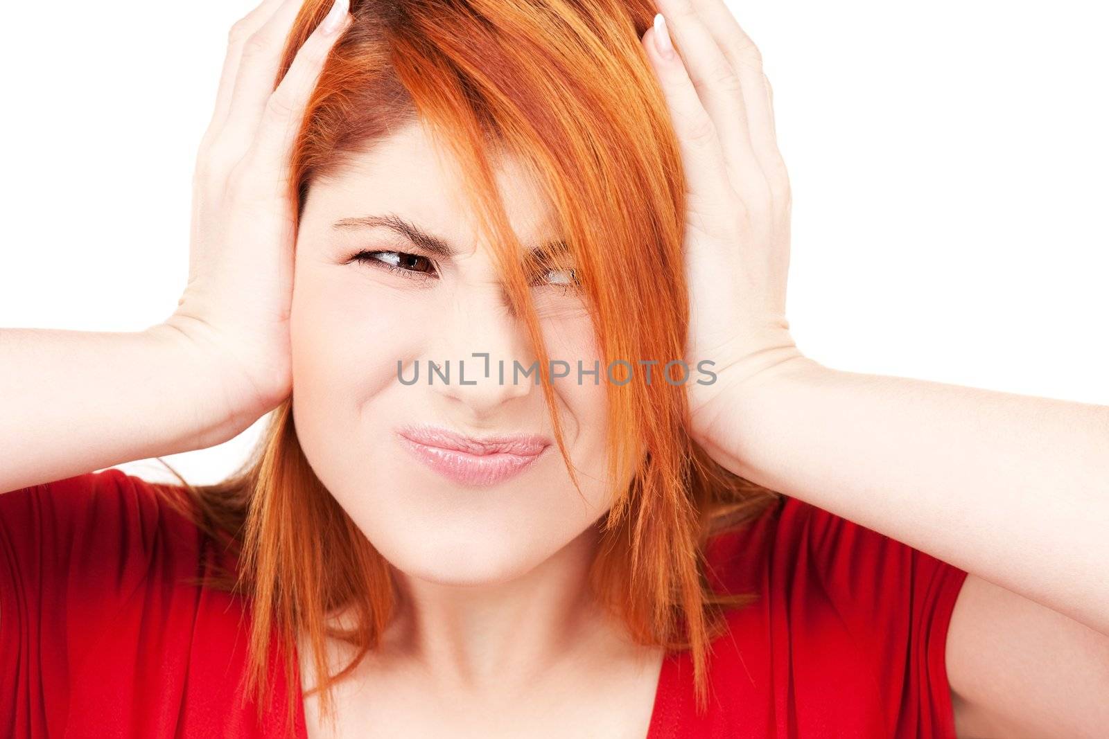 picture of unhappy redhead woman with hands on ears