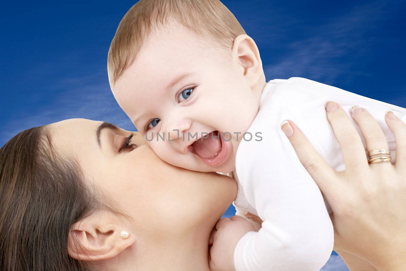 picture of happy mother with baby boy over blue sky