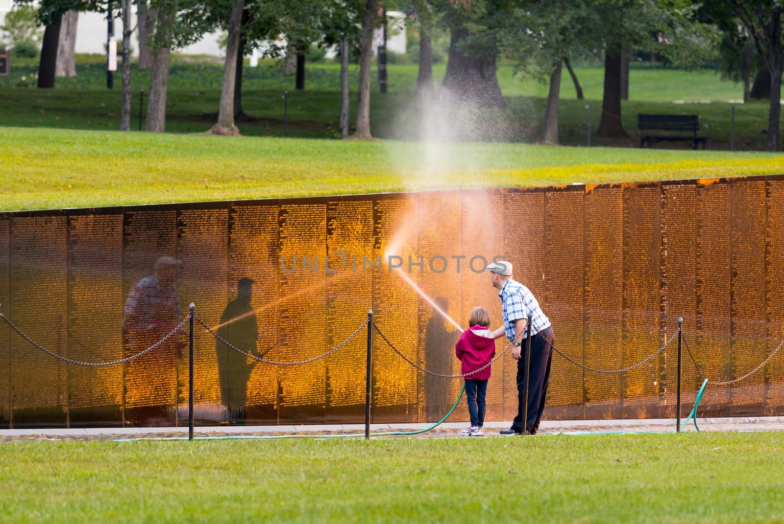 WASHINGTON DC - SEPTEMBER 16: Volunteers clean Vietnam Memorial wall on September 16, 2012. The Wall was completed by Maya Lin in 1982.