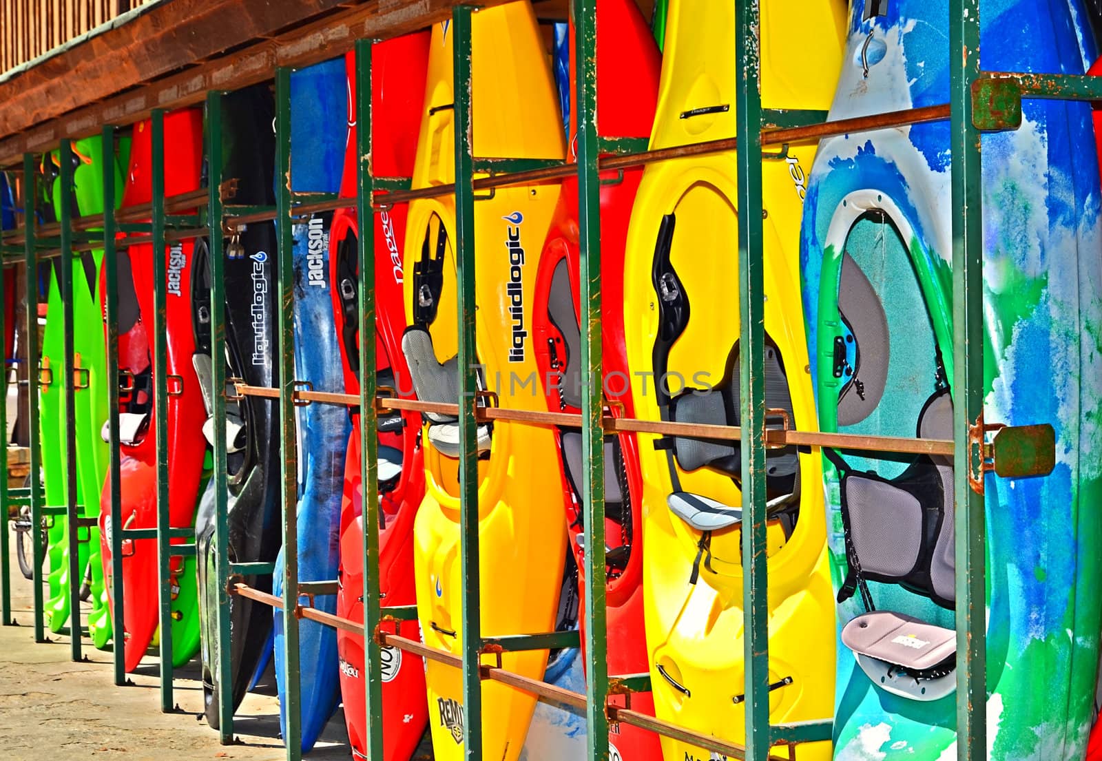 Kayaks on the side of an outdoor center building waiting to be rented.