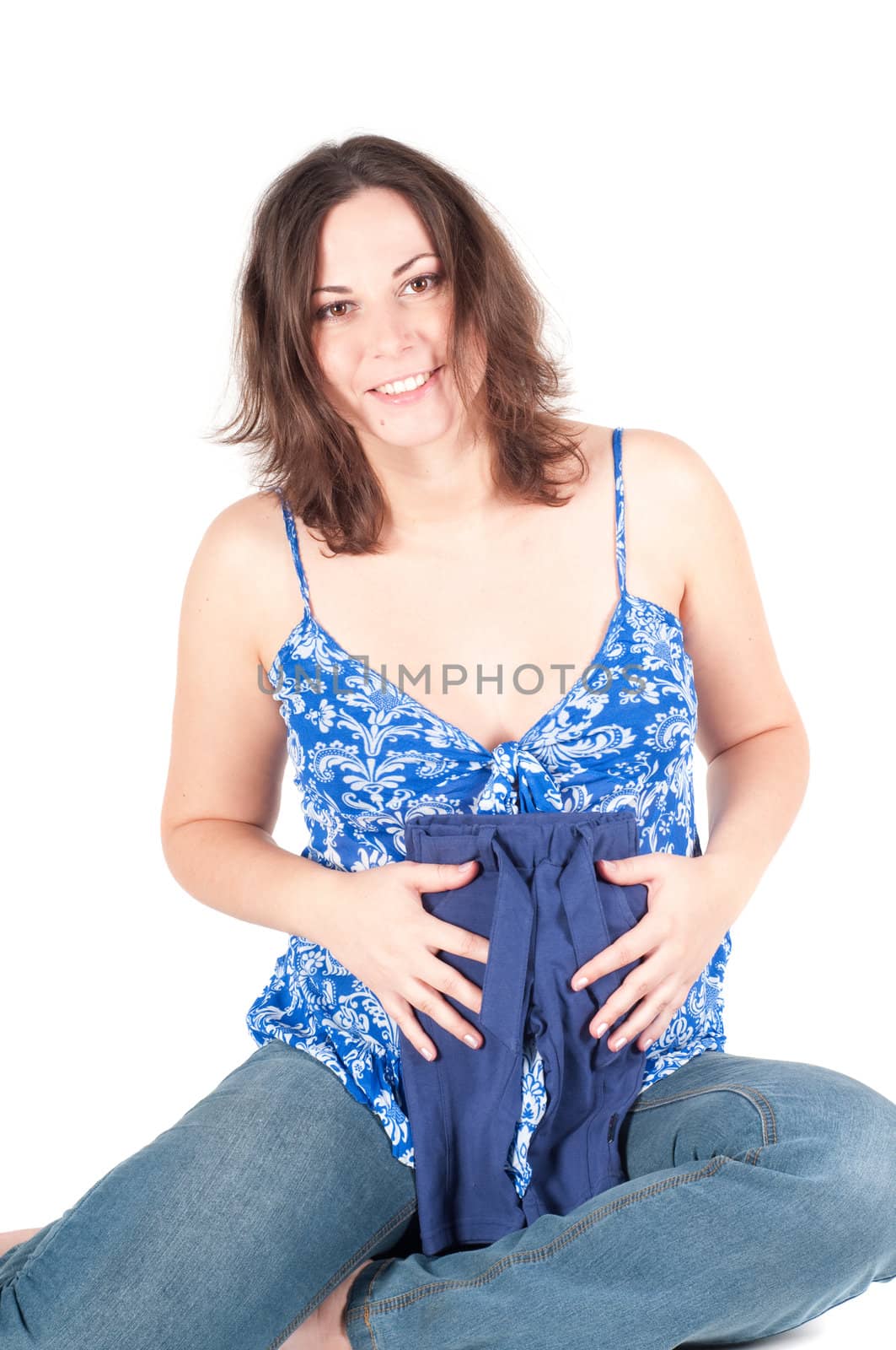 Portrait of pretty pregnant woman with baby clothes isolated on white